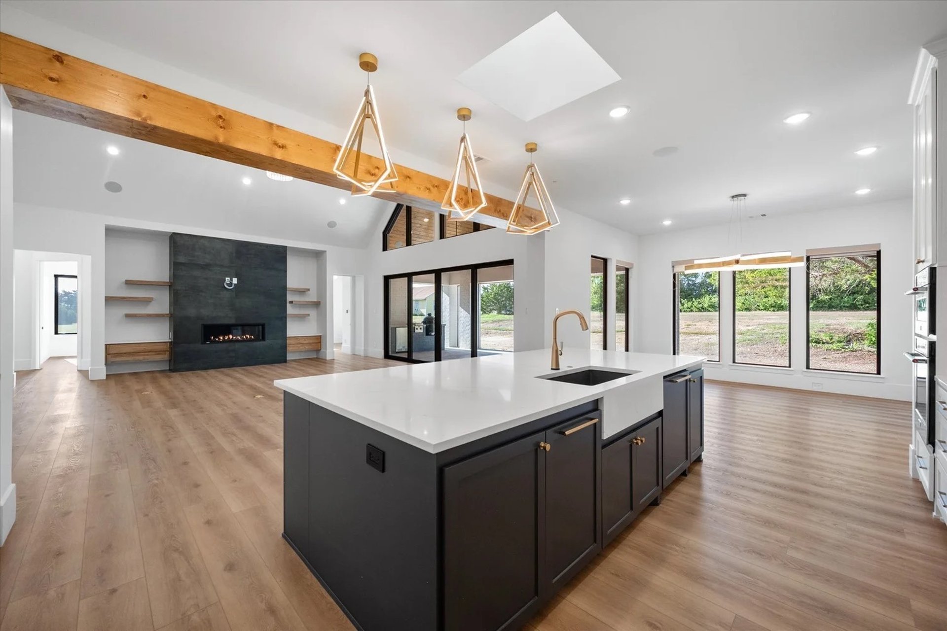 An empty room with hard wood floors and white walls