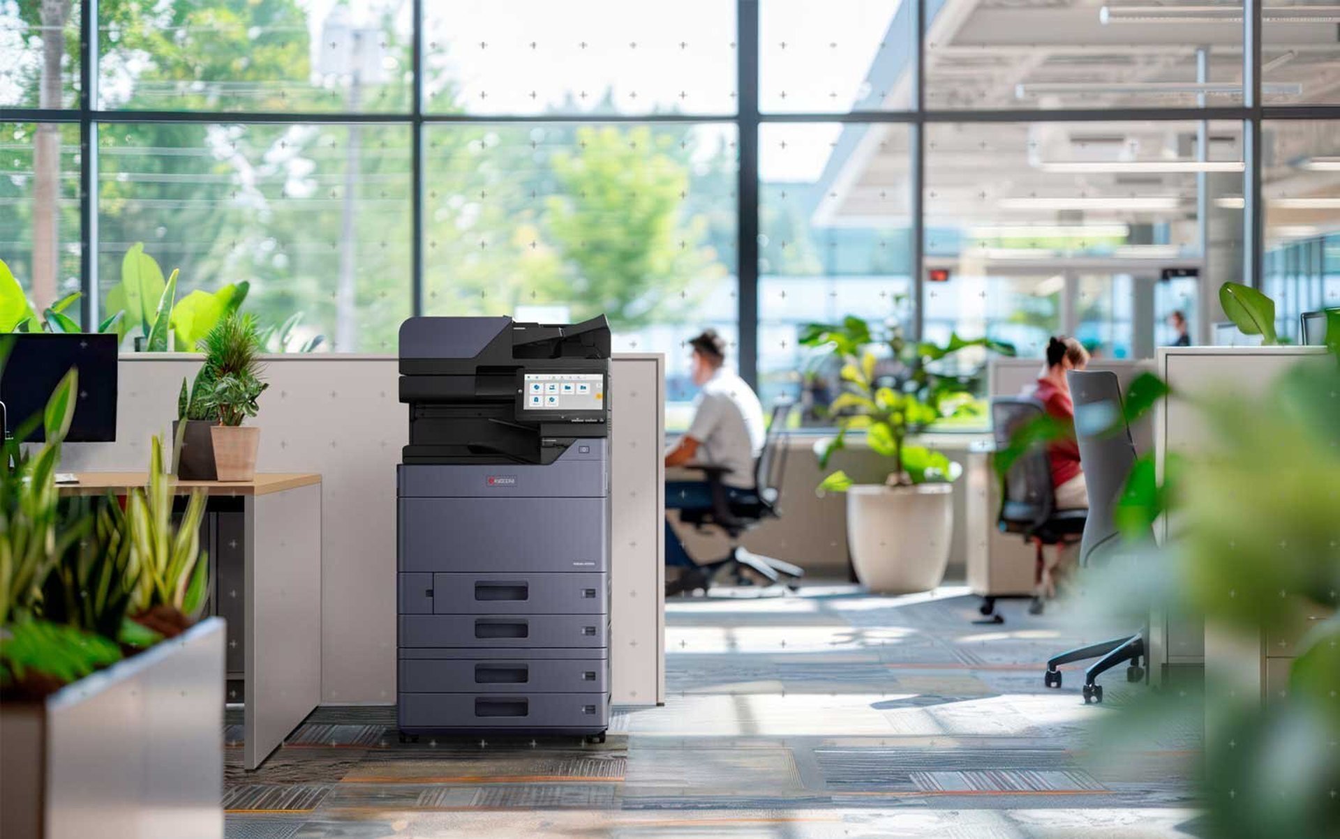 two women sitting at a table with a laptop