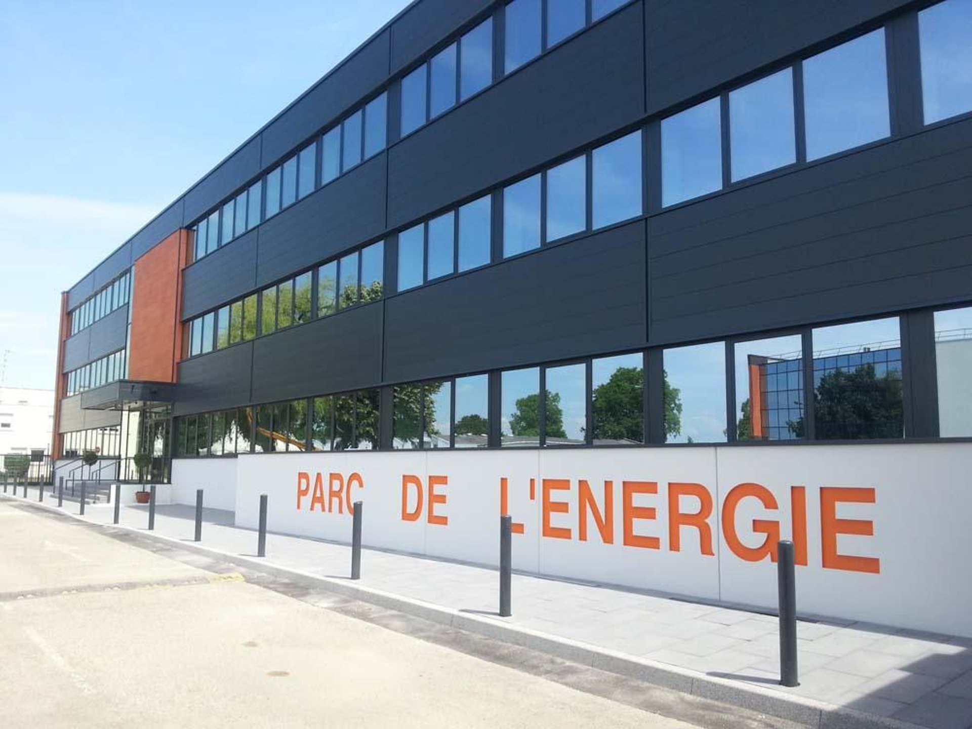 low-angle photography of gray building under blue sky at daytime