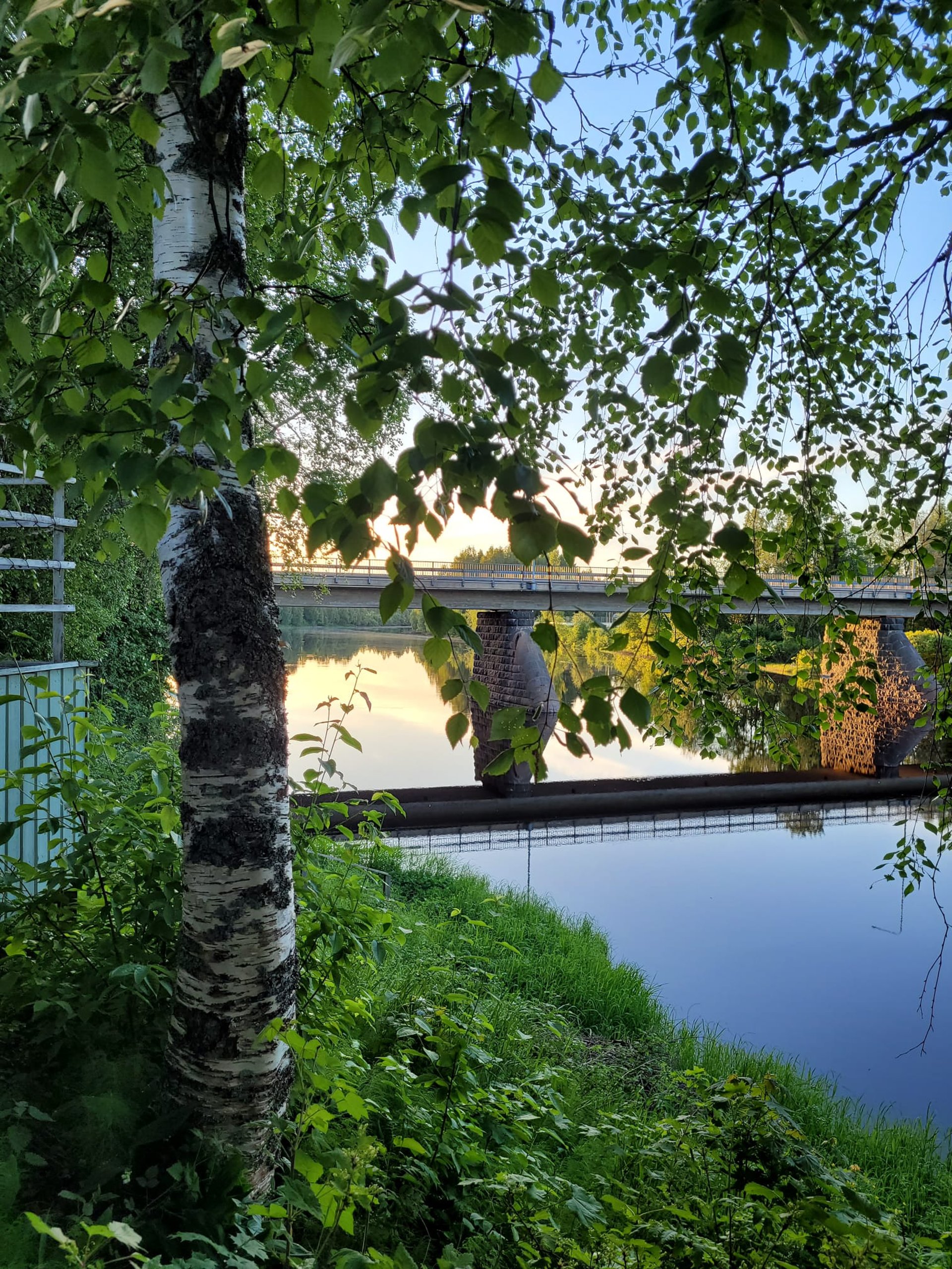 an abstract photo of a curved building with a blue sky in the background