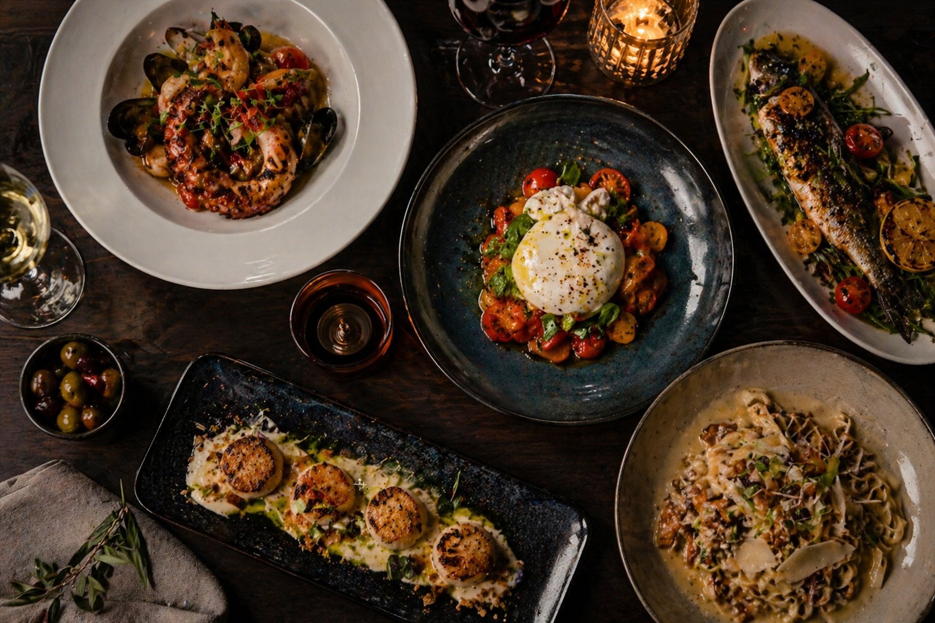 a wooden table topped with plates of food