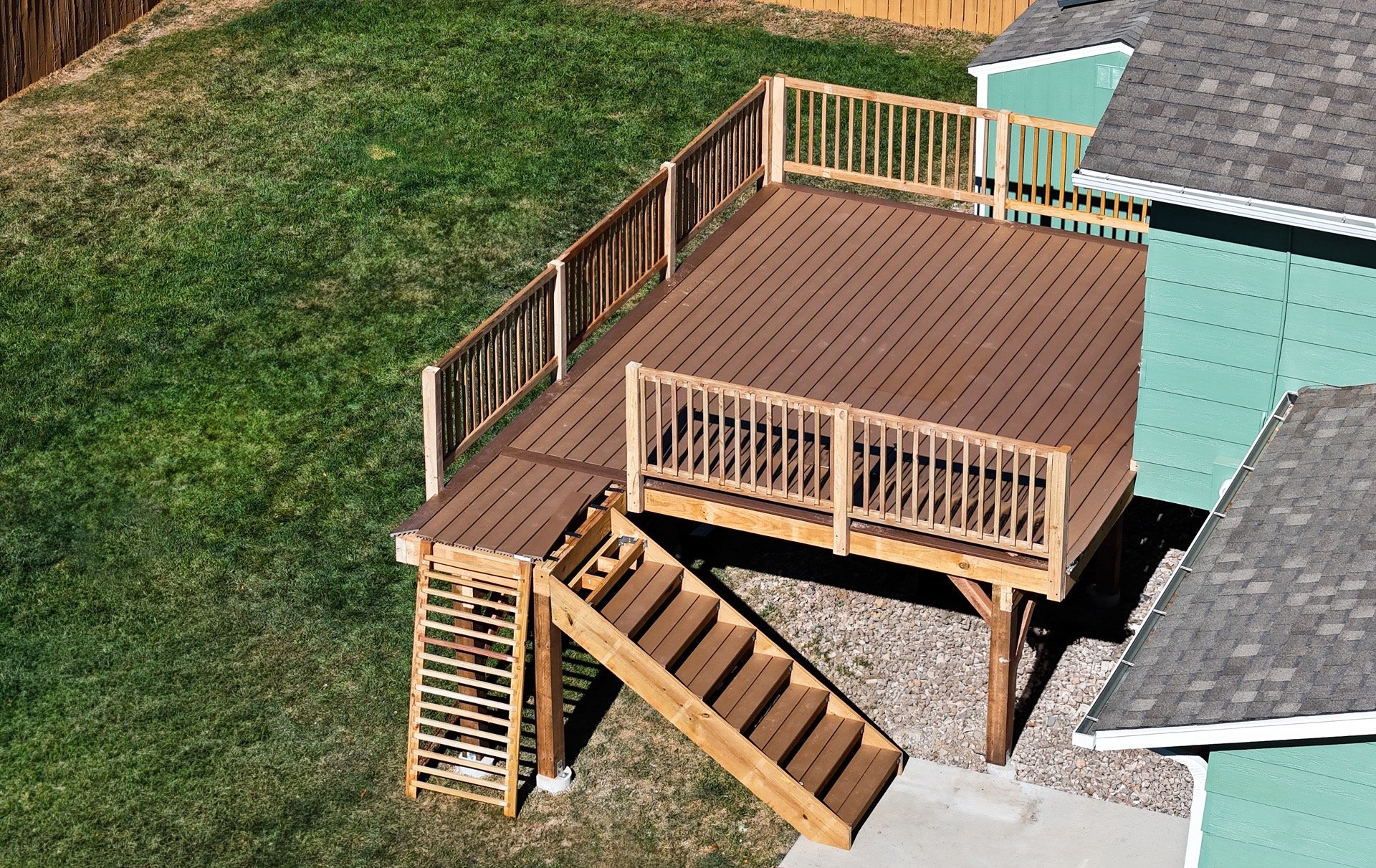 Aerial overview of finished multi-level wood deck and stairs by Brewer Construction in Denver.