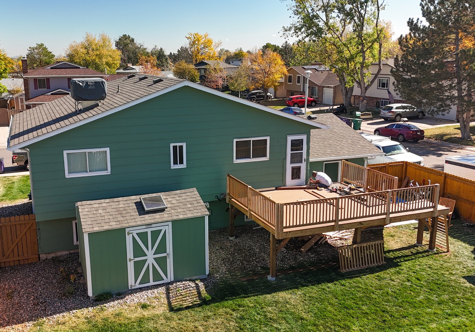 Aerial view of backyard home with completed deck framing and stairs by Brewer Construction in Denver.