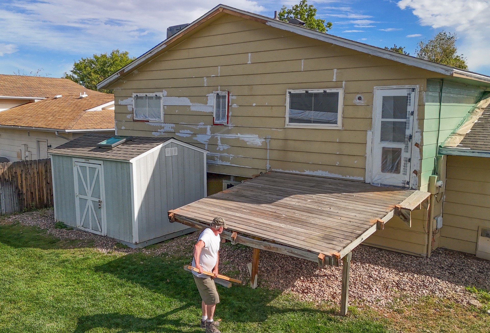 Old wood deck removal and backyard site preparation by Denver contractor Brewer Construction at Iris Court.