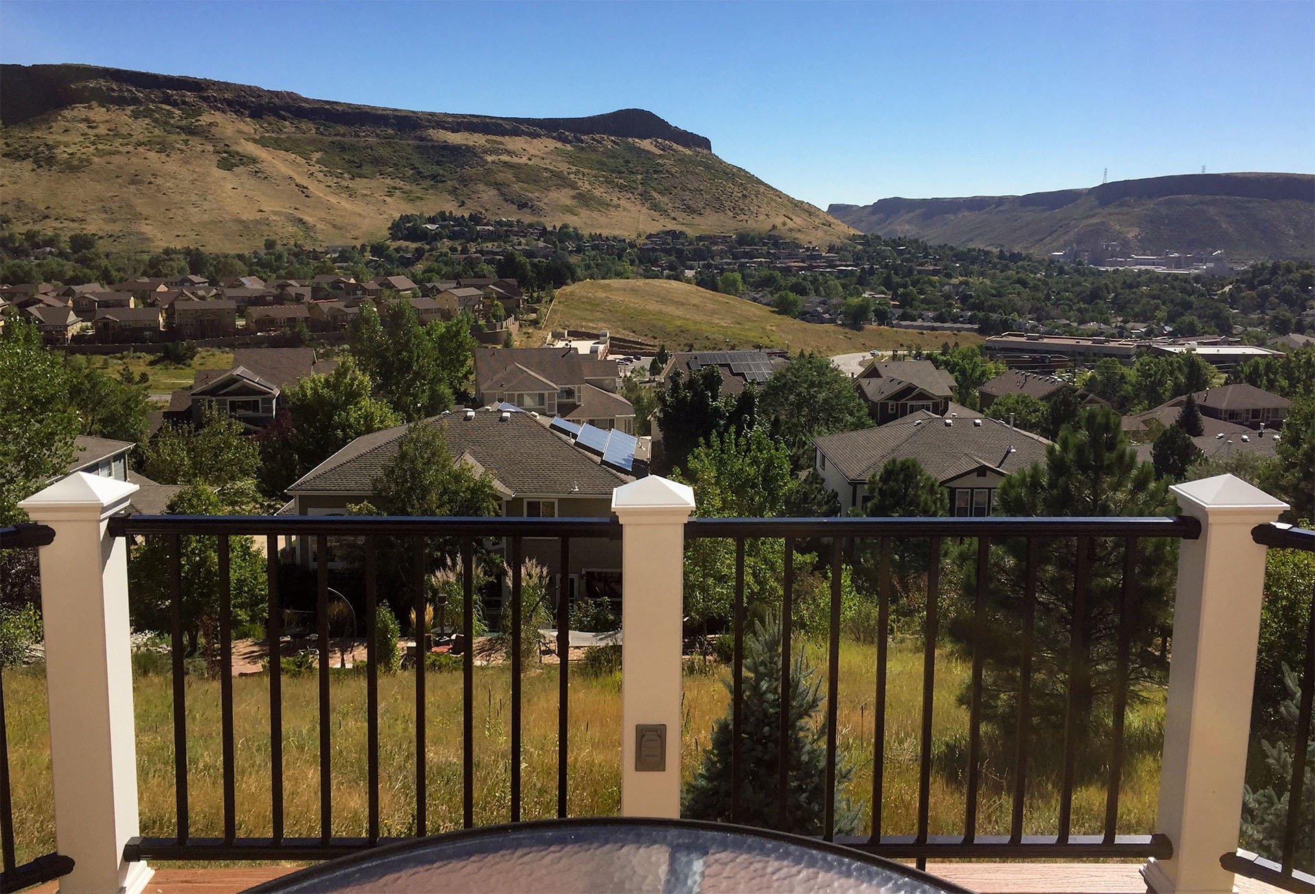 Completed residential wooden deck with stairs leading to a yard, built by Brewer Construction in Golden.