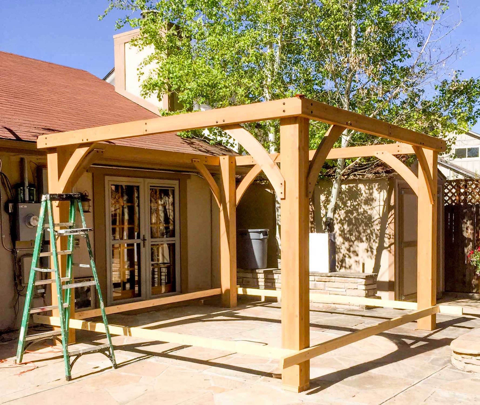 Building the heavy wood frame for a brand-new backyard pergola in Golden, Colorado.