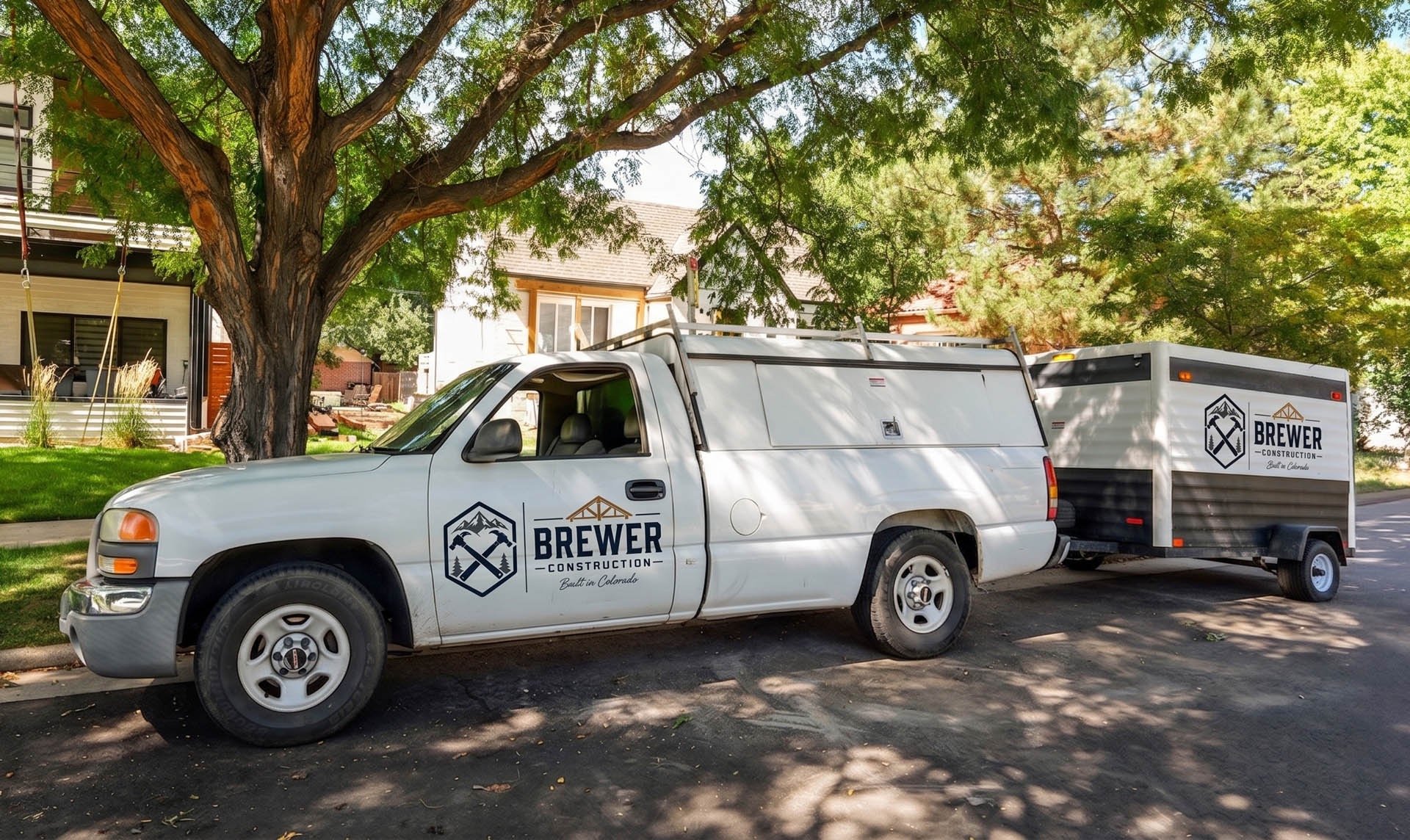 Dennis Brewer Construction work truck parked on a residential street in Denver.