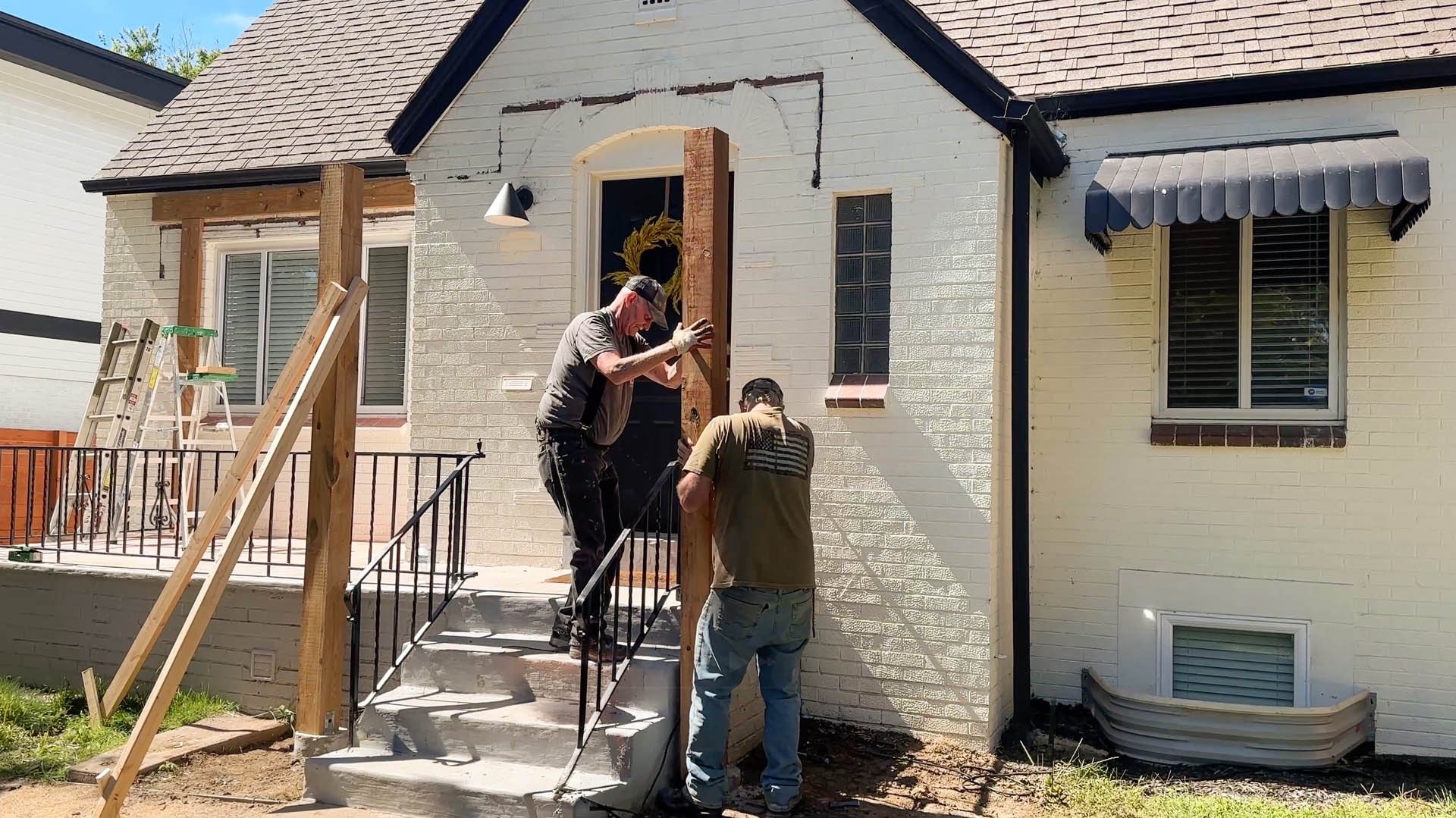 Two professional carpenters framing a custom home entry portico in Lookout Mountain.