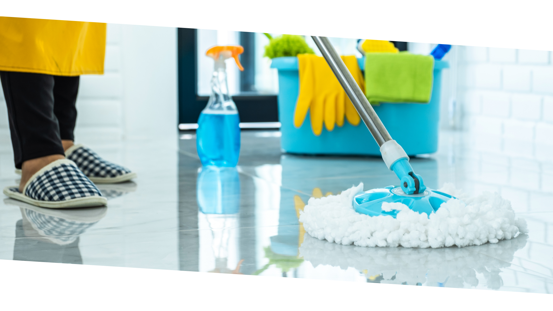 person in blue gloves holding white textile