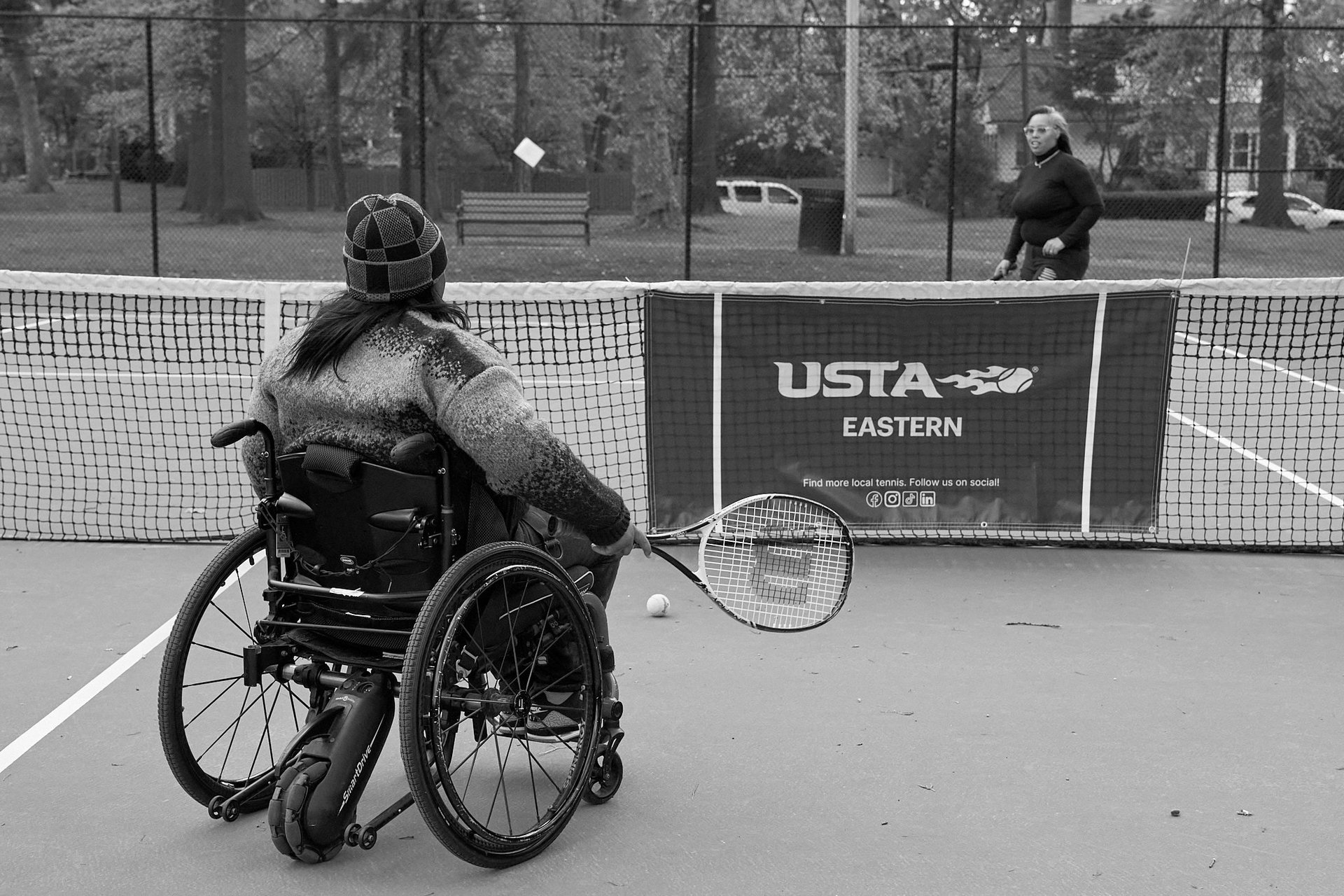 A group of men riding on the backs of wheelchairs