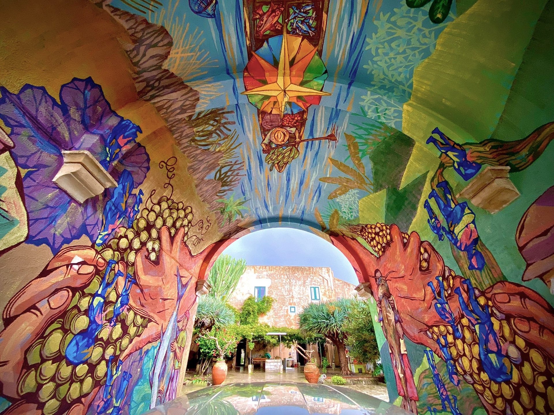 an abstract photo of a curved building with a blue sky in the background