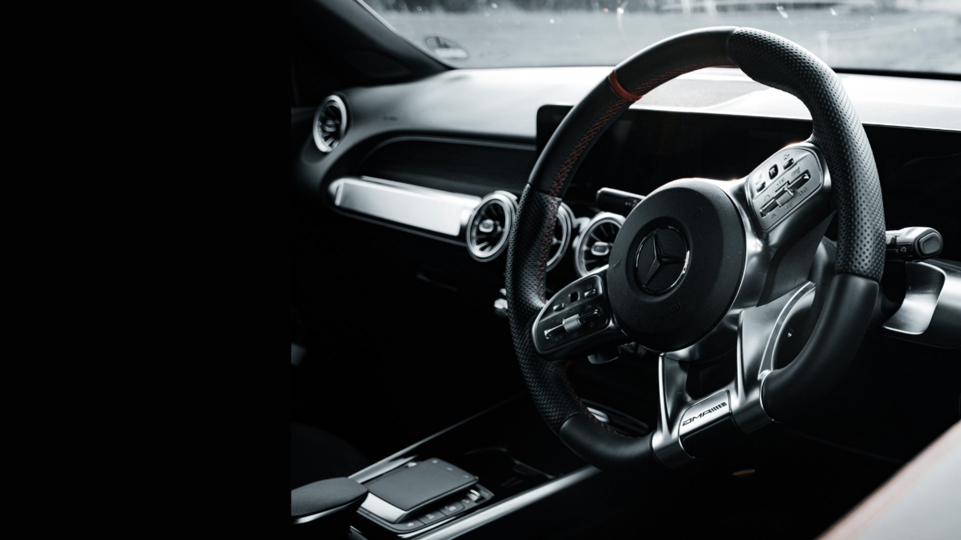 Mercedes-benz steering wheel inside a car.