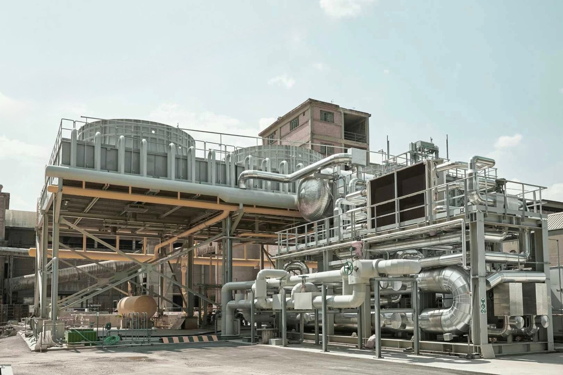 gray and black factory under blue sky during daytime