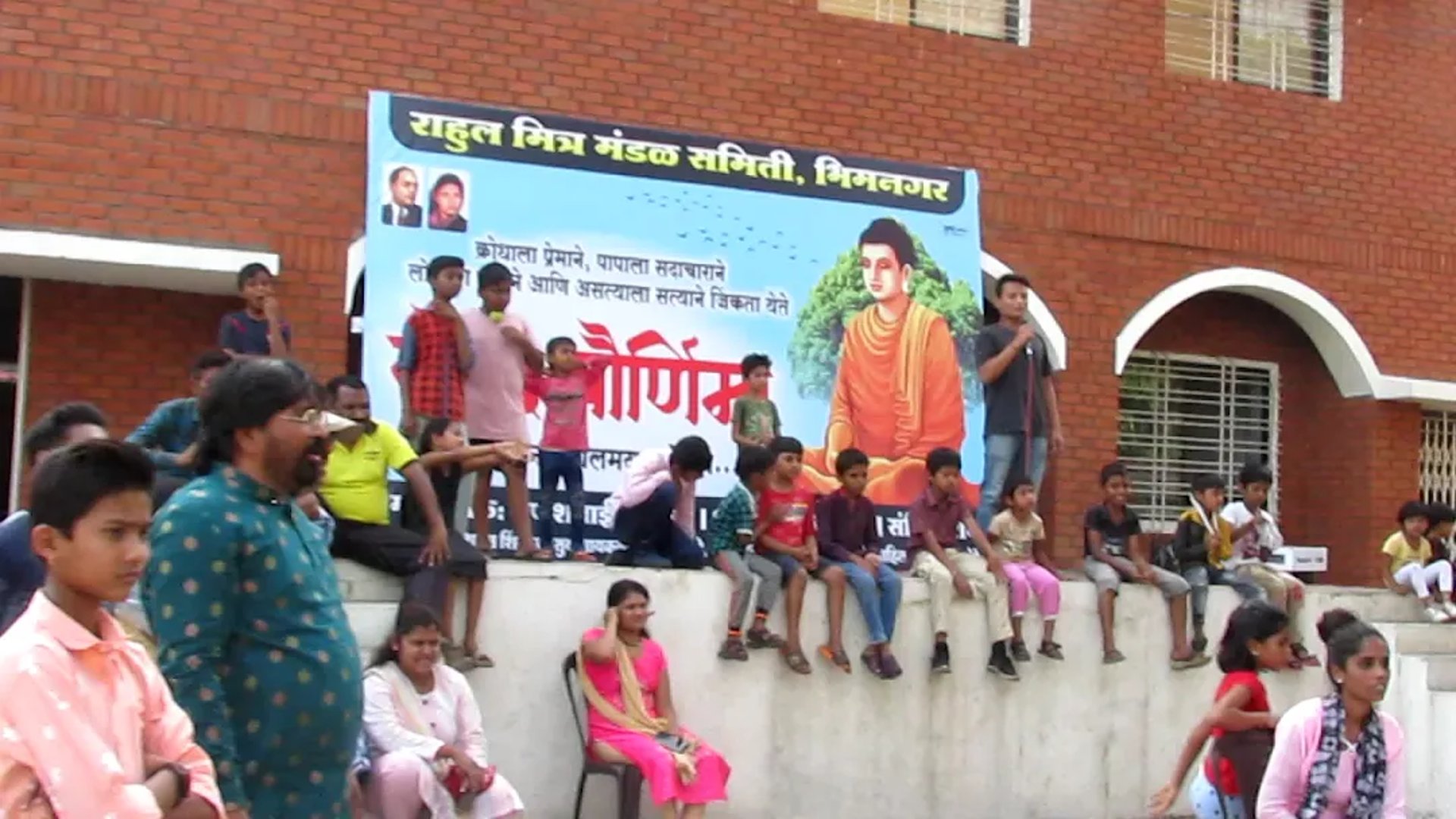 people holding shoulders sitting on wall