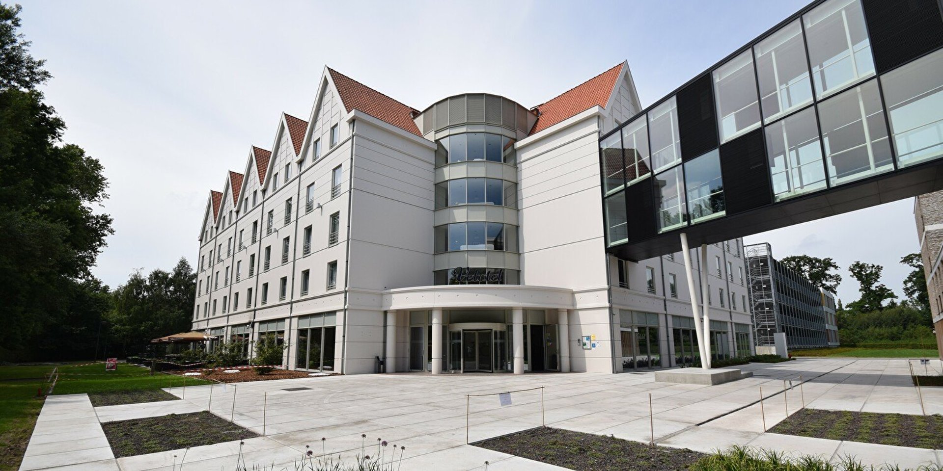 an abstract photo of a curved building with a blue sky in the background