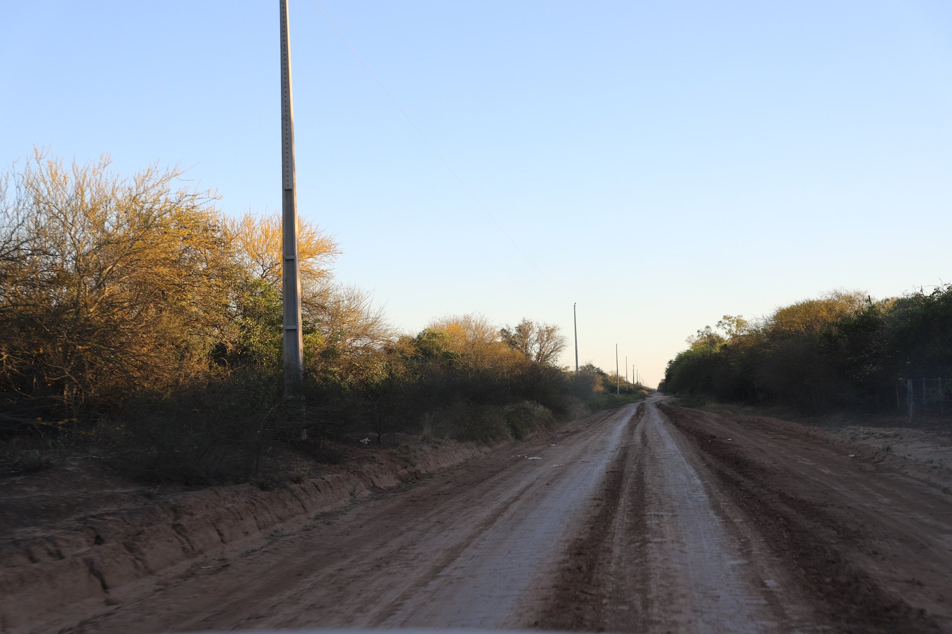 person in red sweater holding babys hand