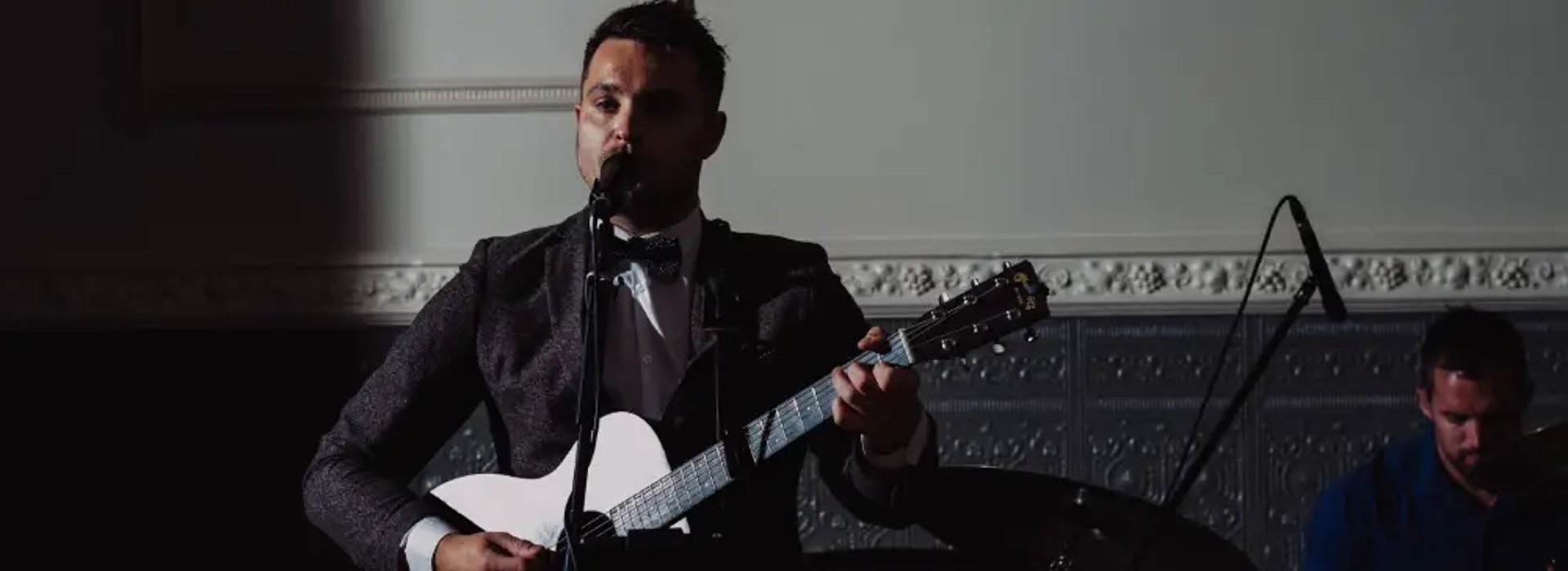 Lead singer of Mosaic performing soulful Americana vocals at a wedding in Devon