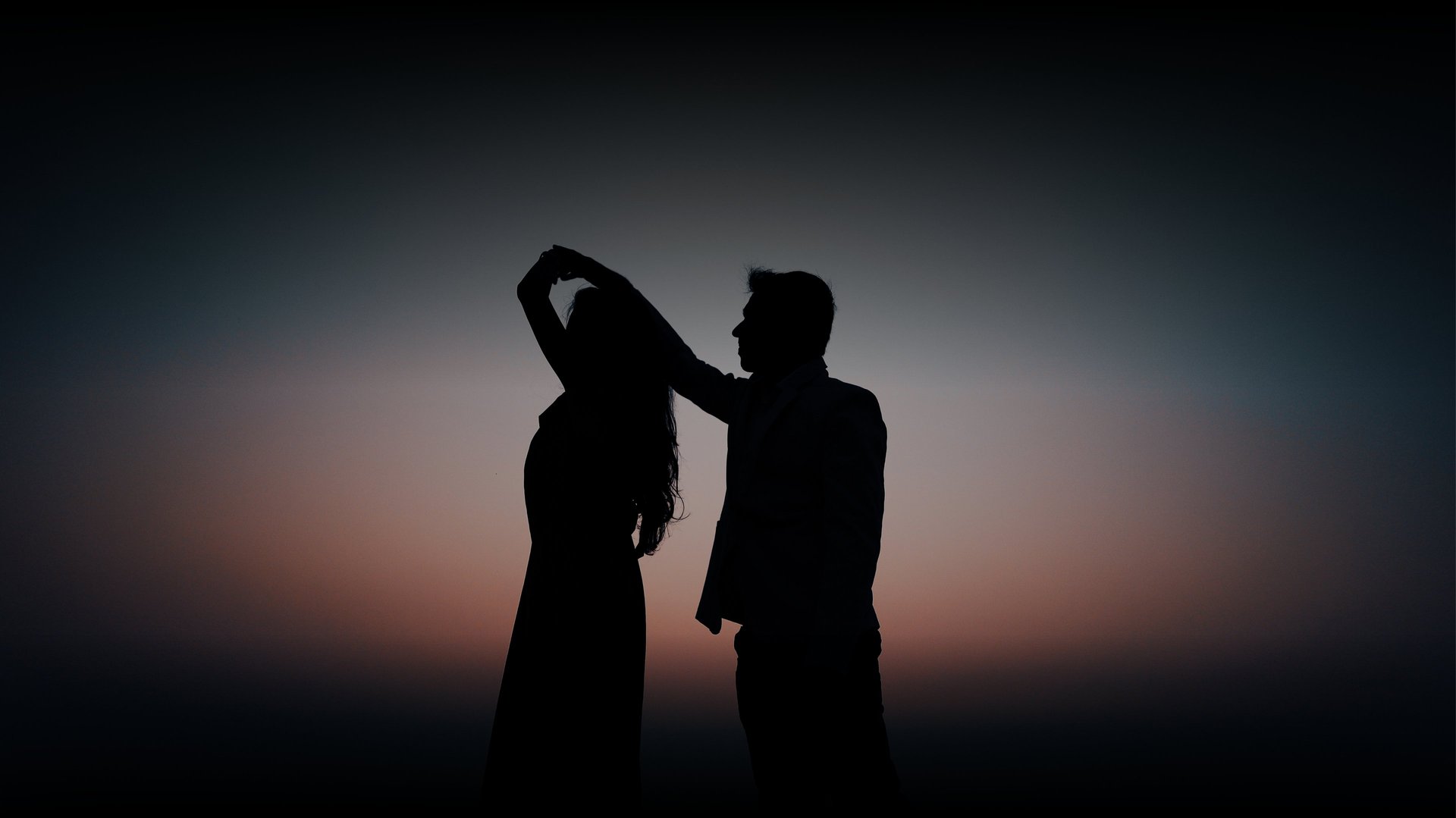 an abstract photo of a curved building with a blue sky in the background