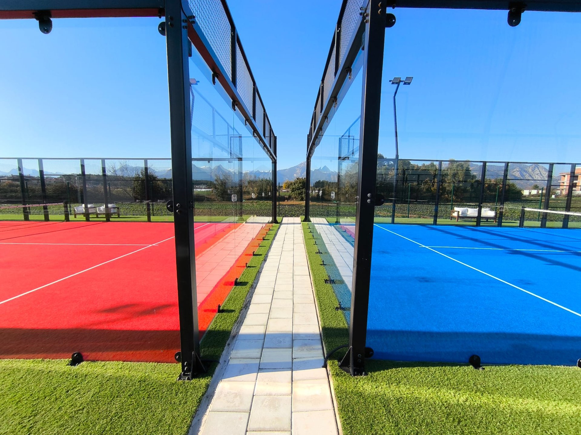 a tennis court with chairs and tables on the grass