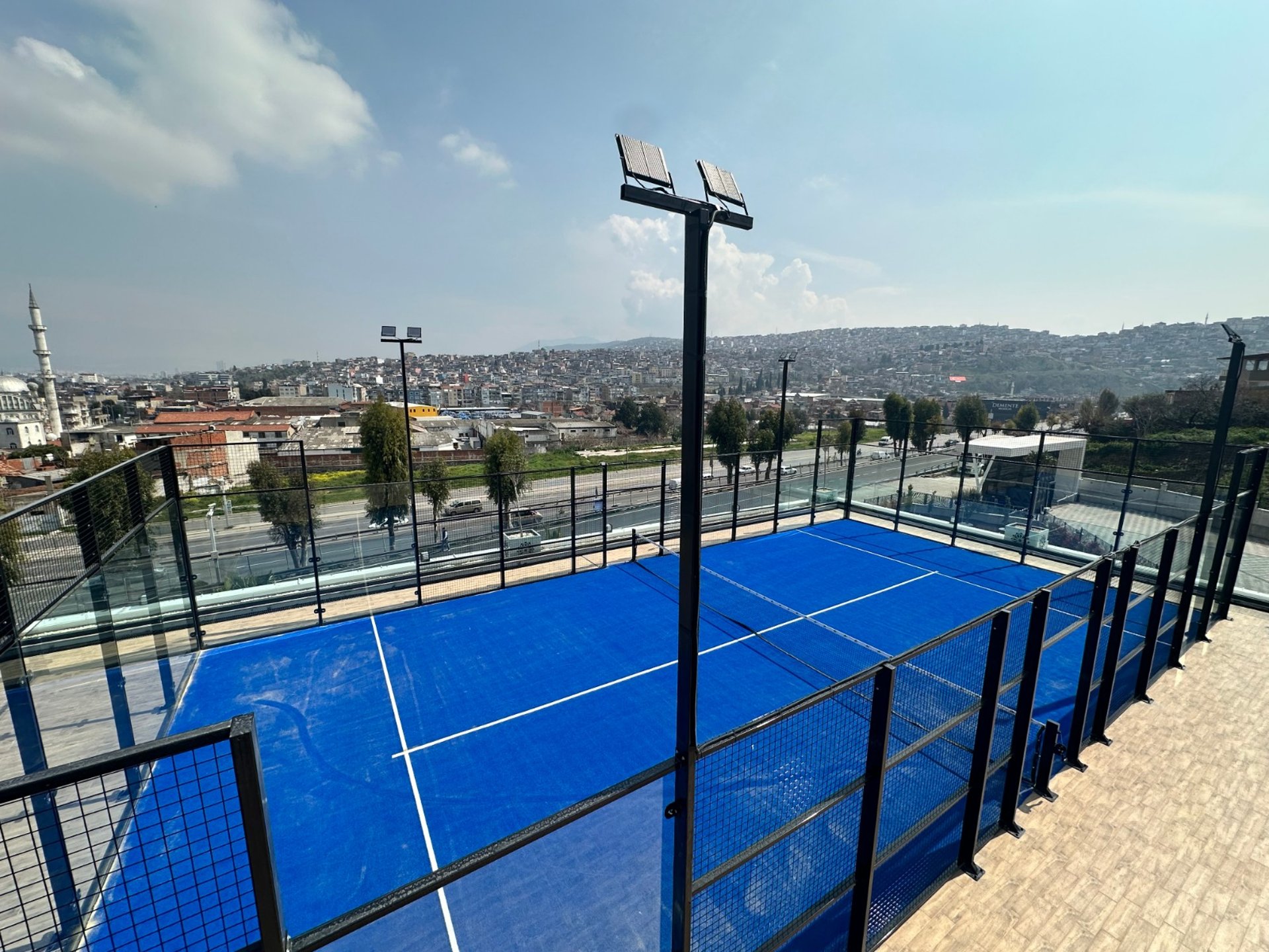 a tennis court with a blue tarp on it