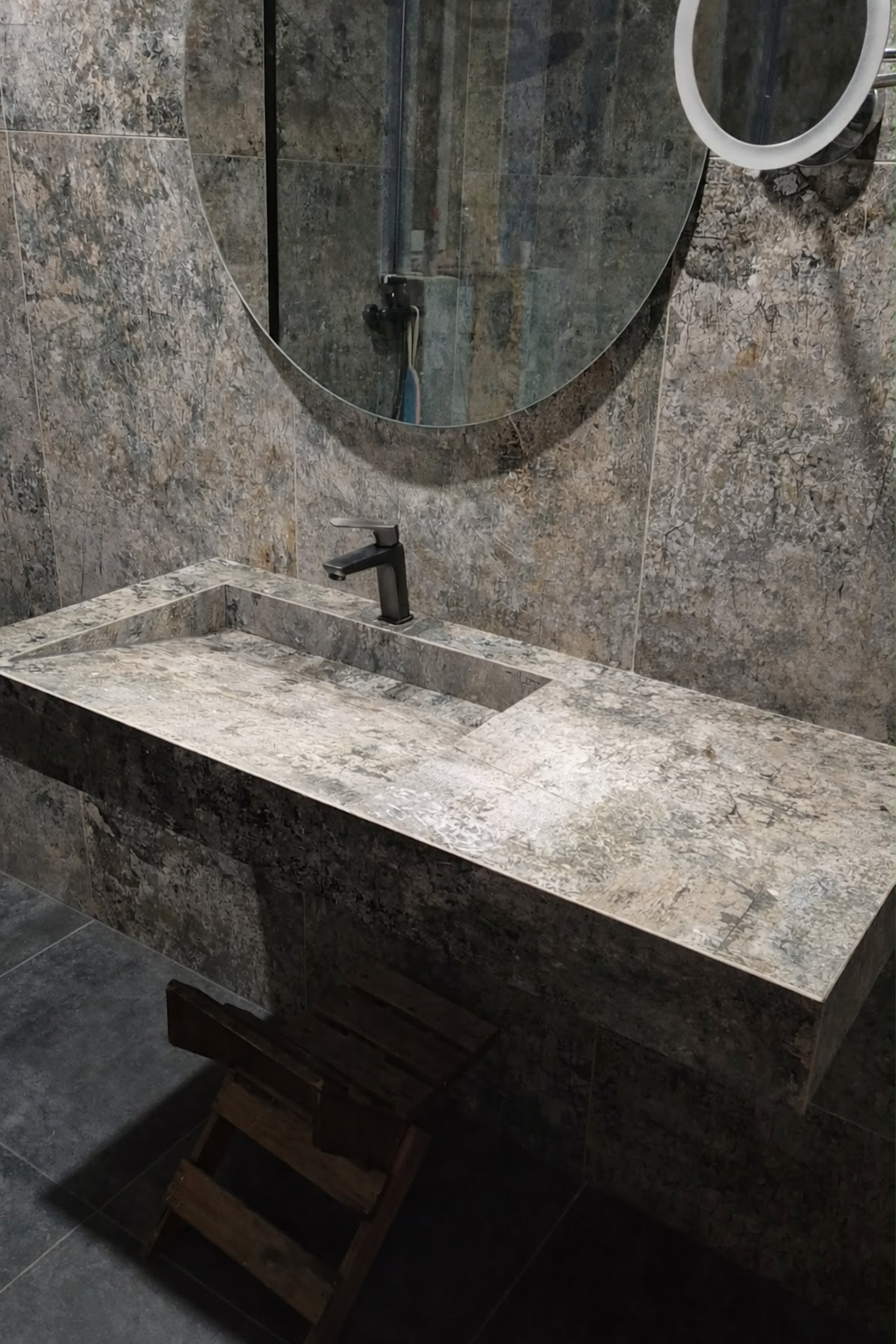 A white sink sitting on top of a marble counter