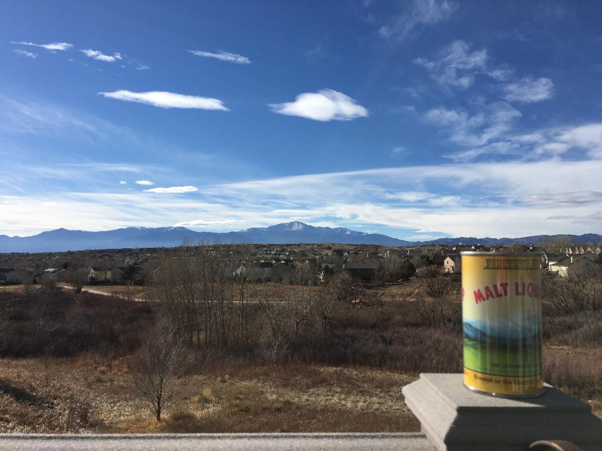 assorted plastic bottles on brown wooden shelf