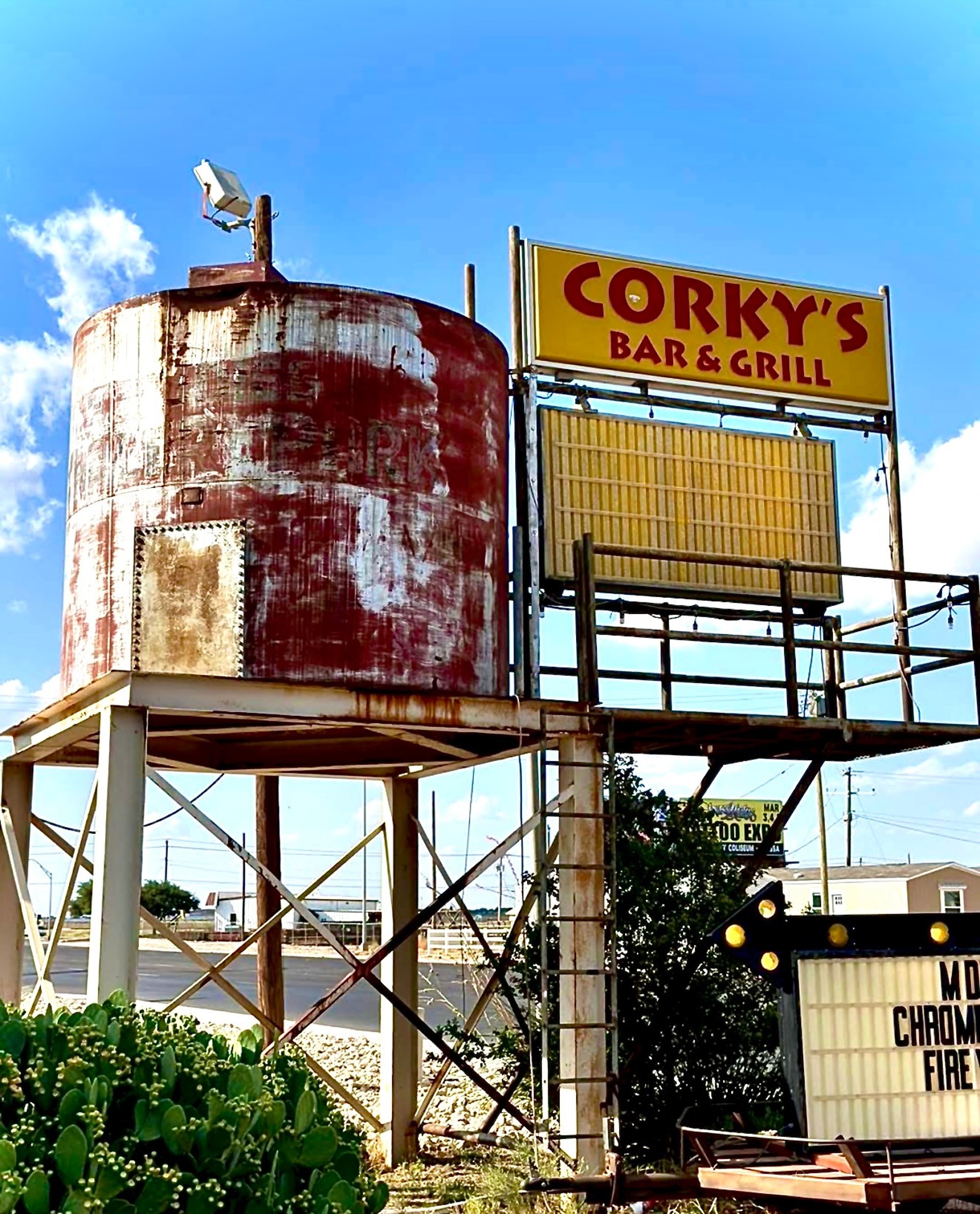 an abstract photo of a curved building with a blue sky in the background