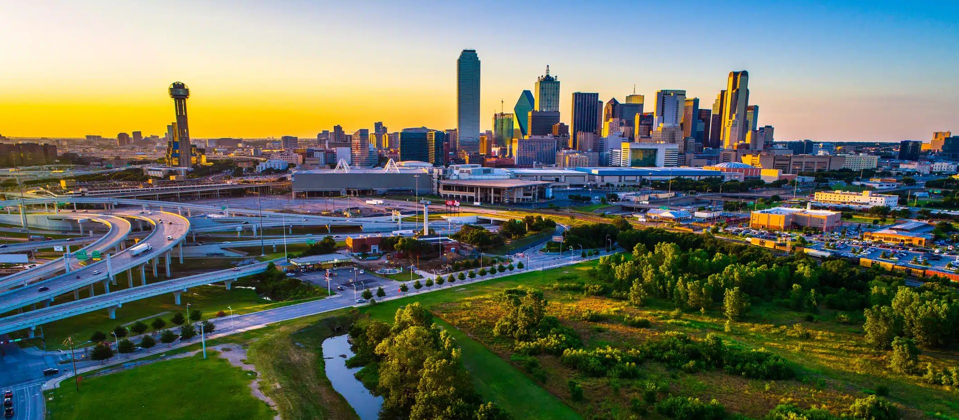 an abstract photo of a curved building with a blue sky in the background