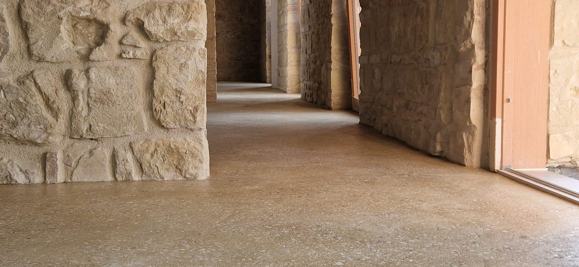 shiny rammed earth floor in a stone house