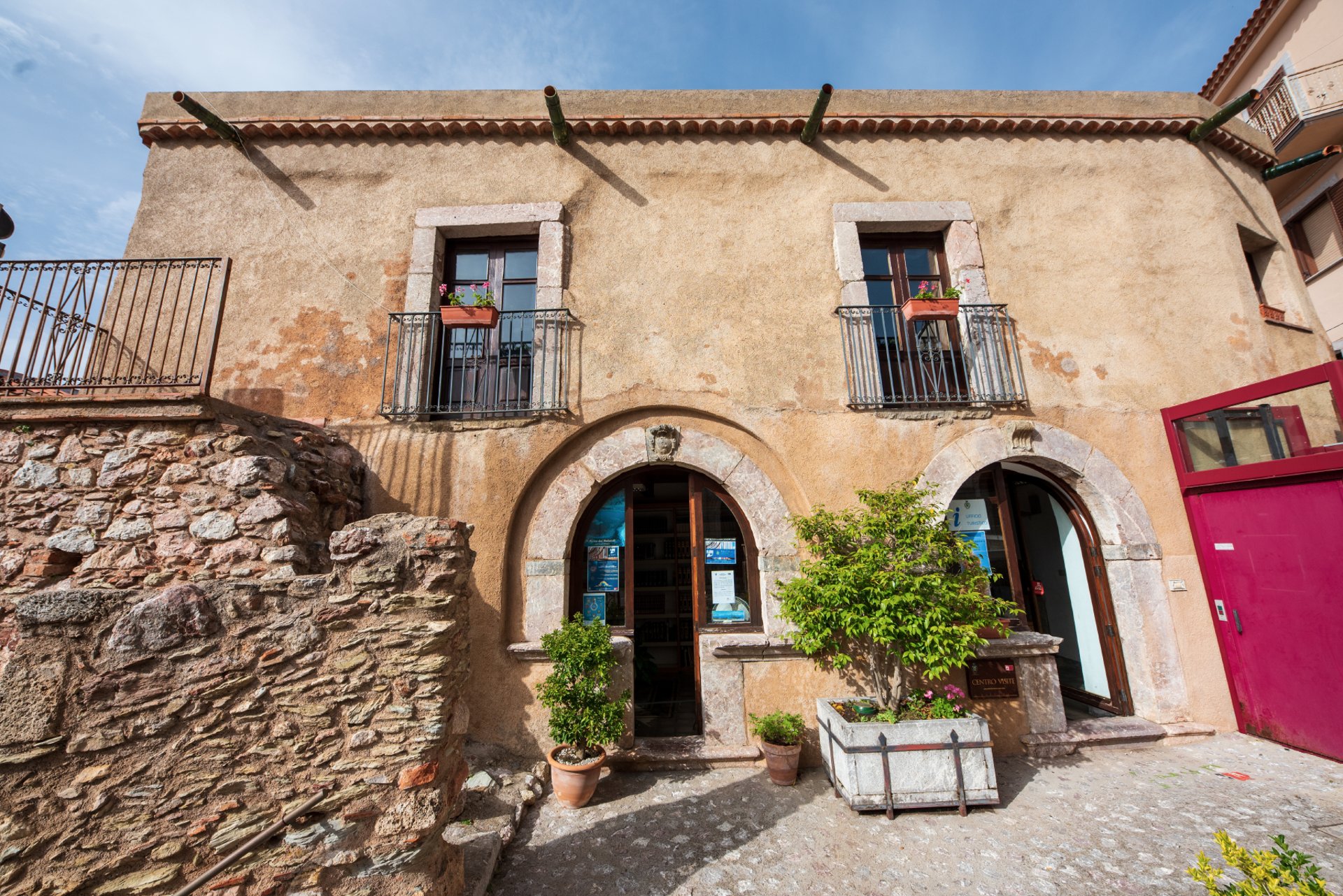 an abstract photo of a curved building with a blue sky in the background