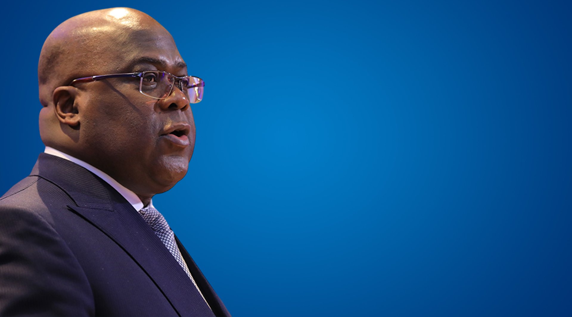 an abstract photo of a curved building with a blue sky in the background