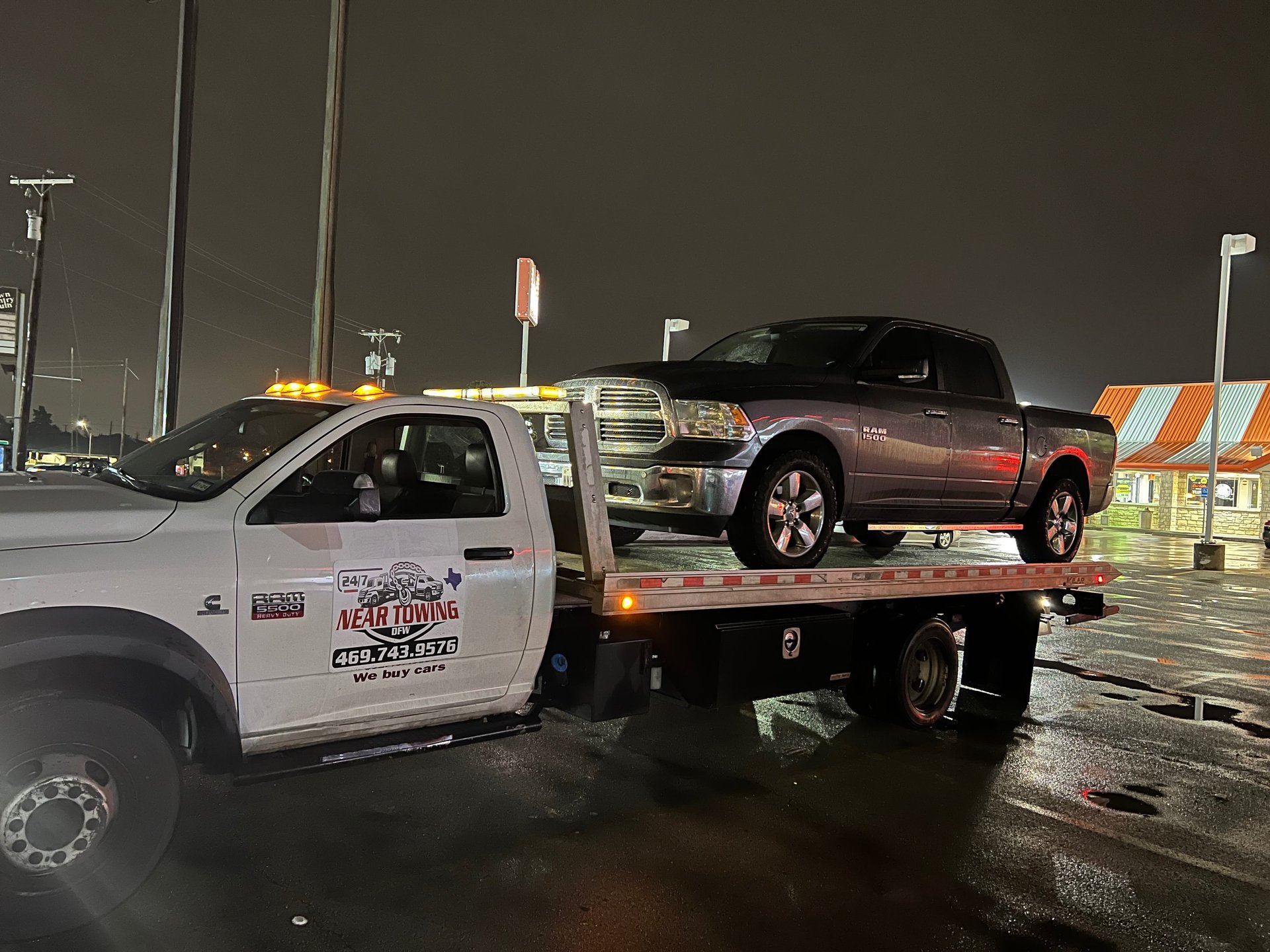 a red car is on a flatbed tow truck