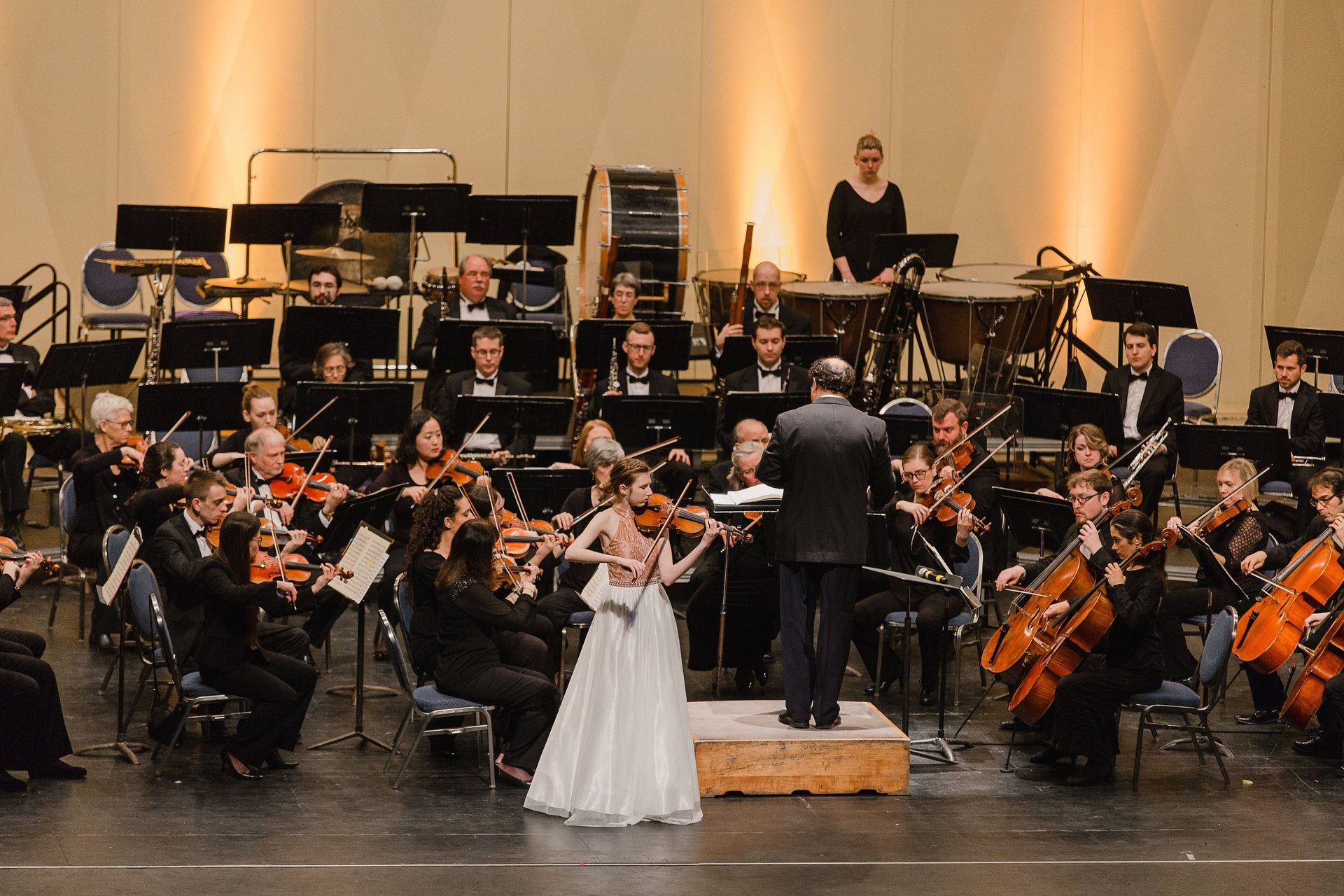 an abstract photo of a curved building with a blue sky in the background
