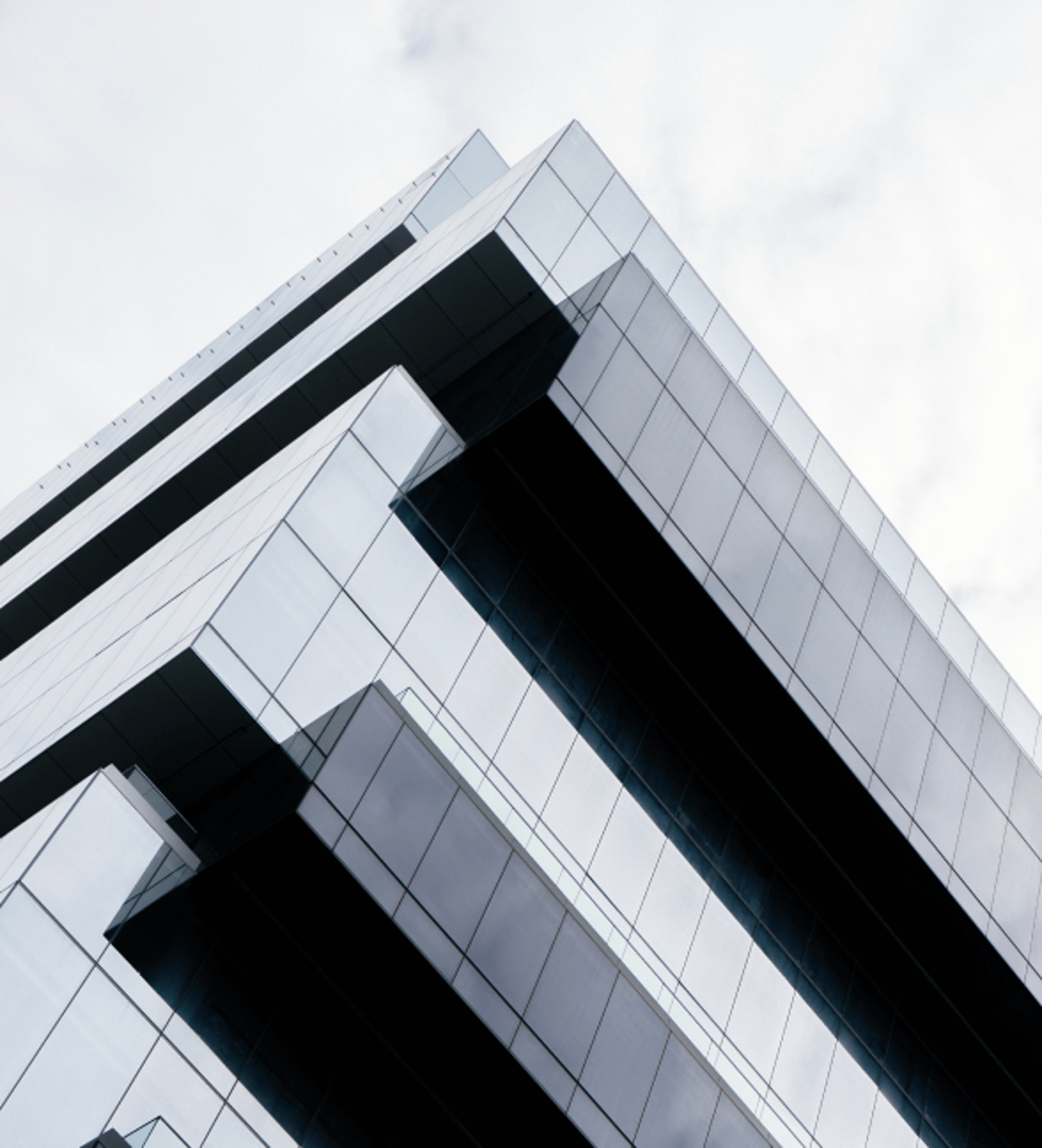 an abstract photo of a curved building with a blue sky in the background