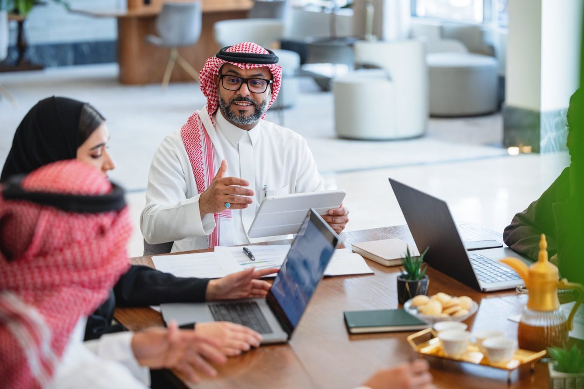 people sitting near table with laptop computer