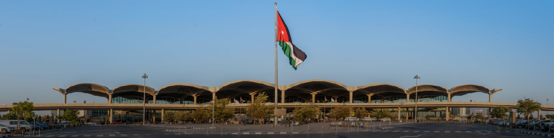 an abstract photo of a curved building with a blue sky in the background