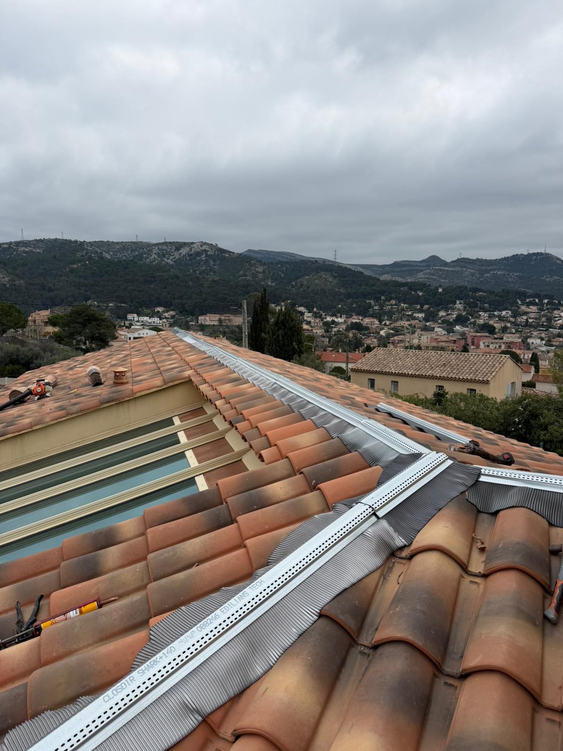 a person wearing blue gloves and holding a hammer