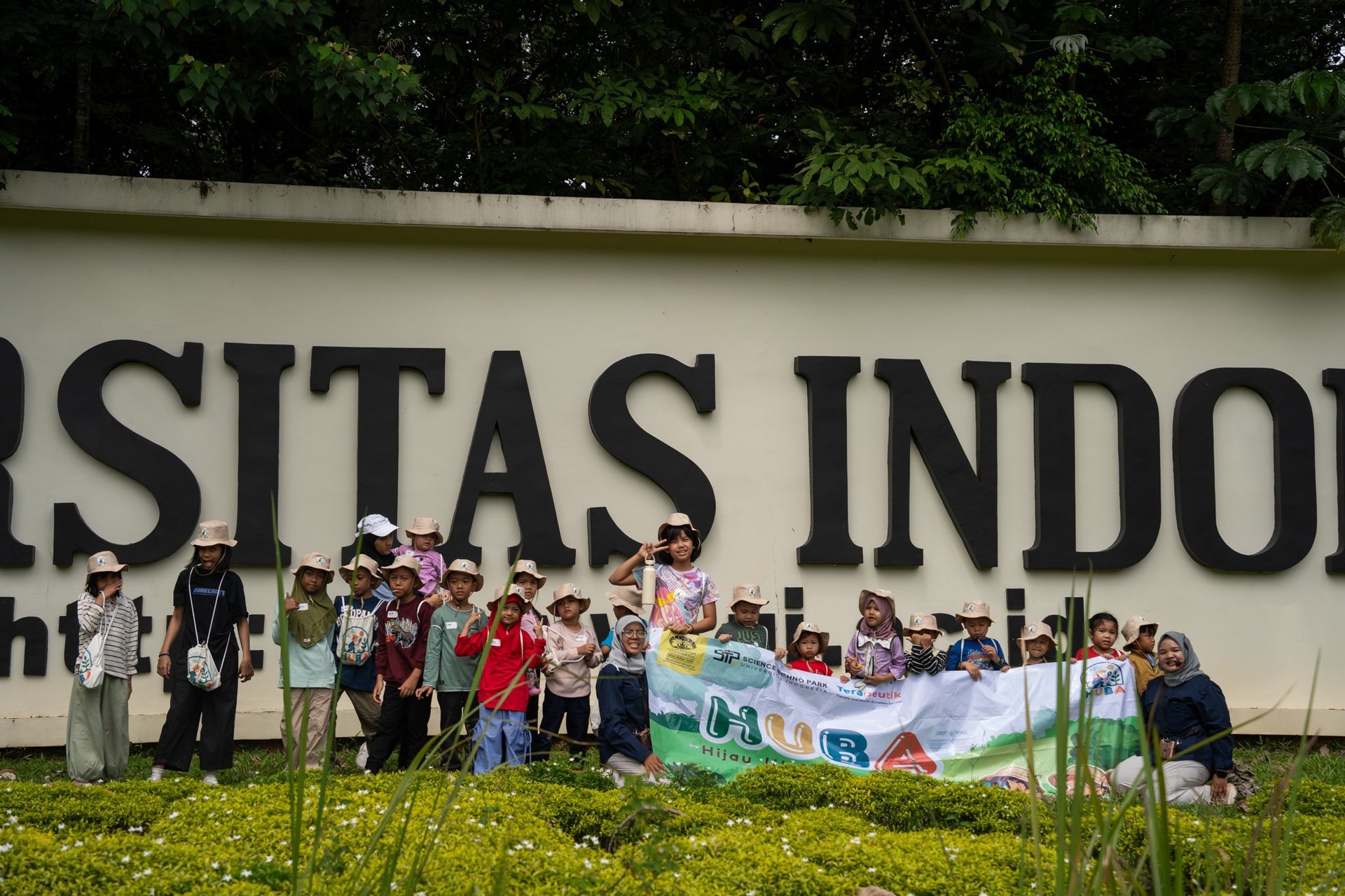 boy in green jacket and red shirt running on road during daytime