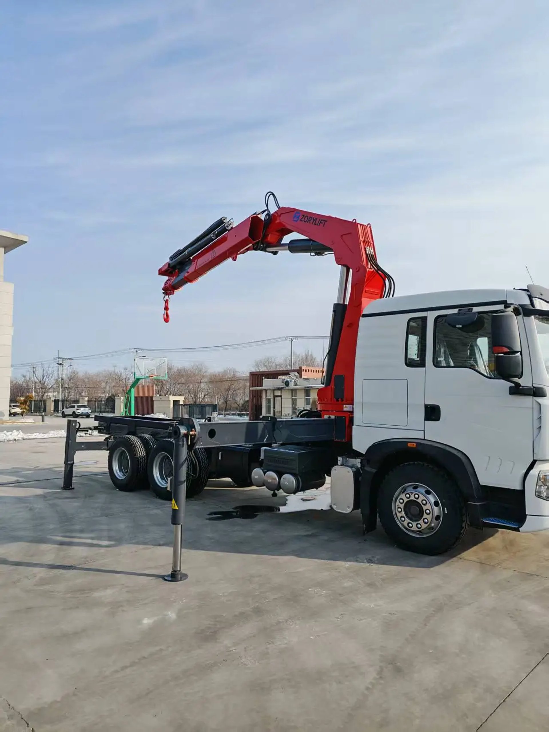 a crane is lifting a shipping container onto a truck