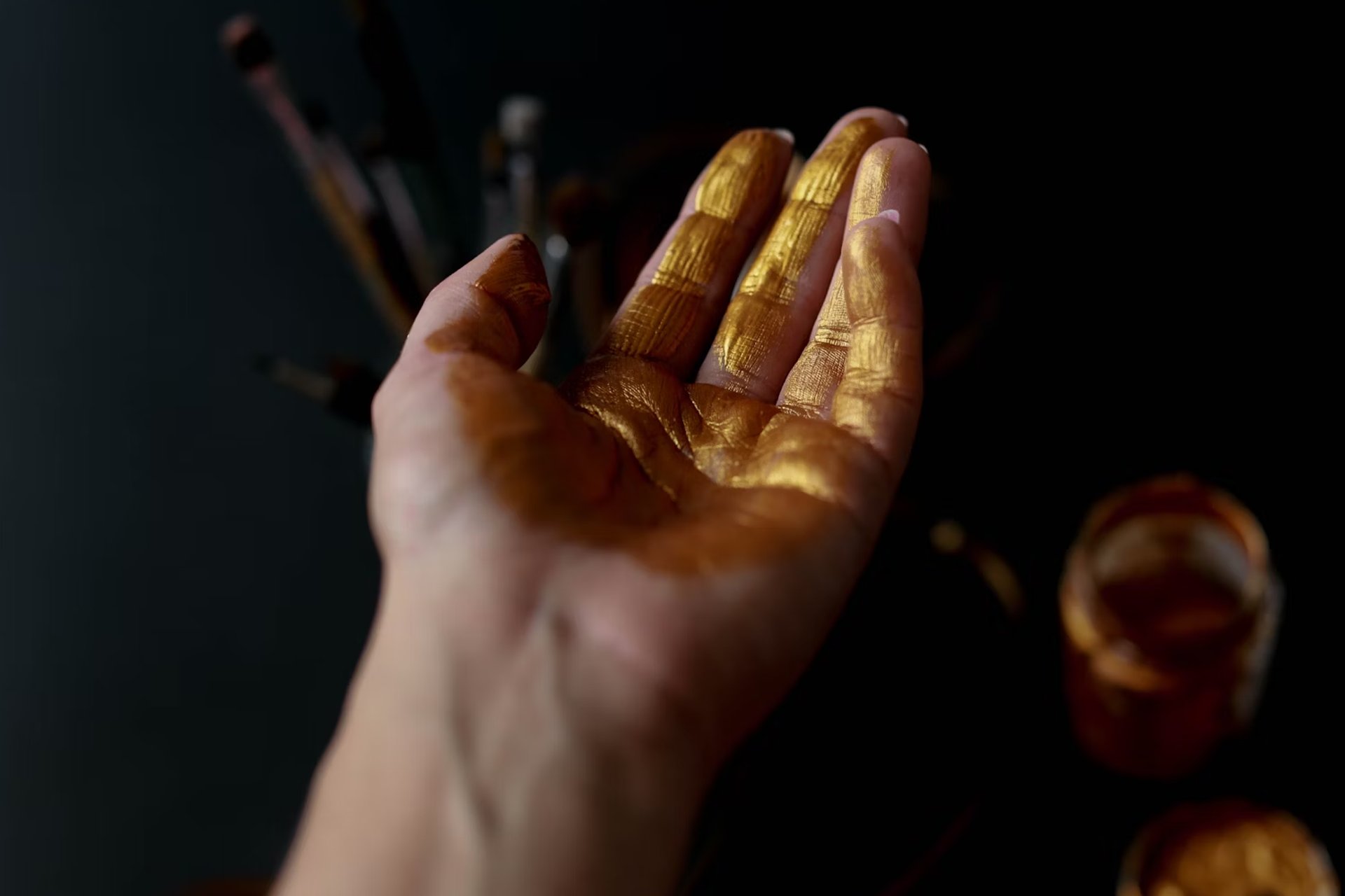 four color bottles near paint brushes