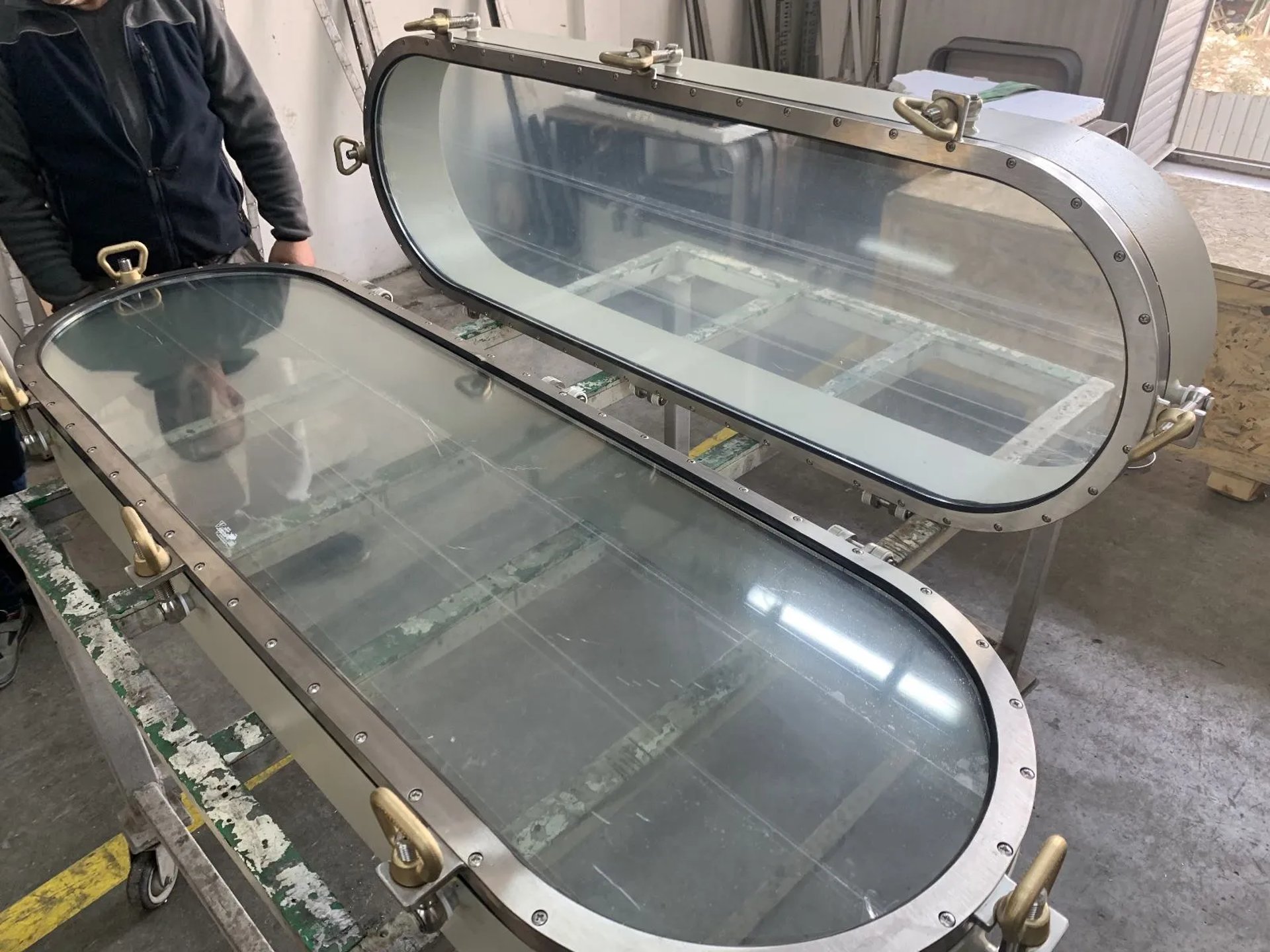 Oblong stainless ship windows in workshop