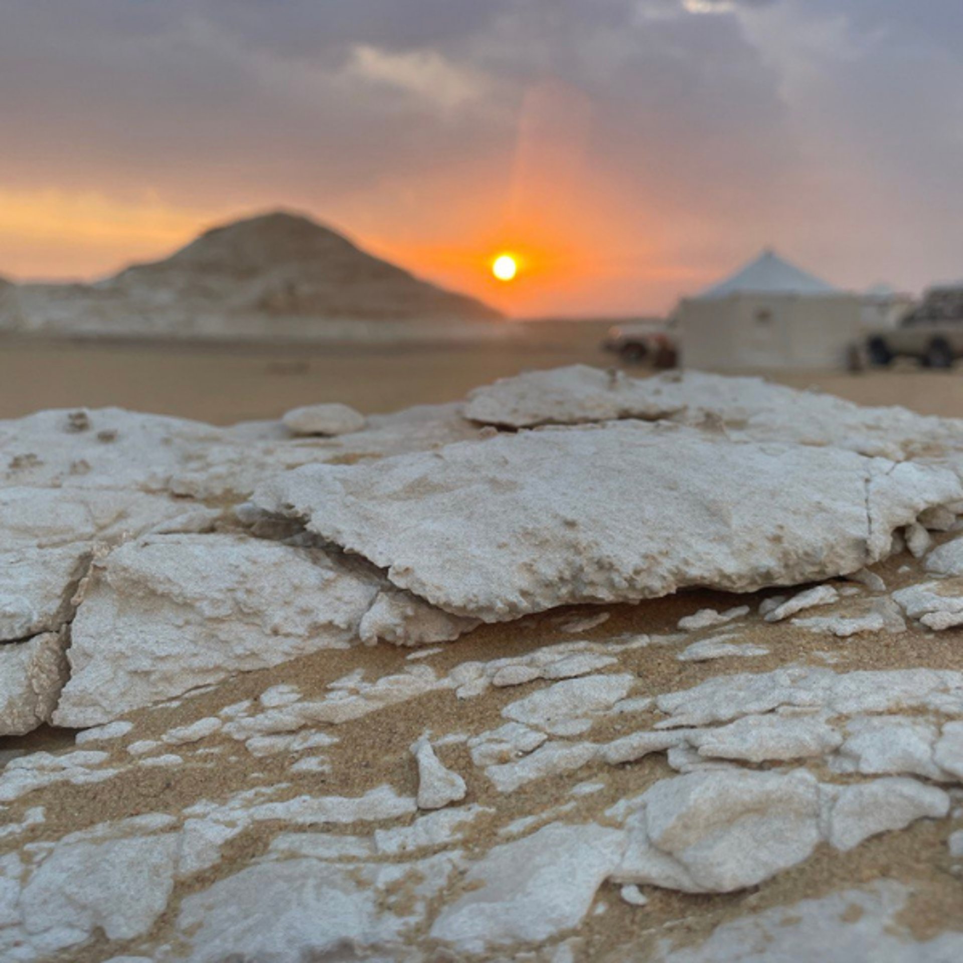 an abstract photo of a curved building with a blue sky in the background