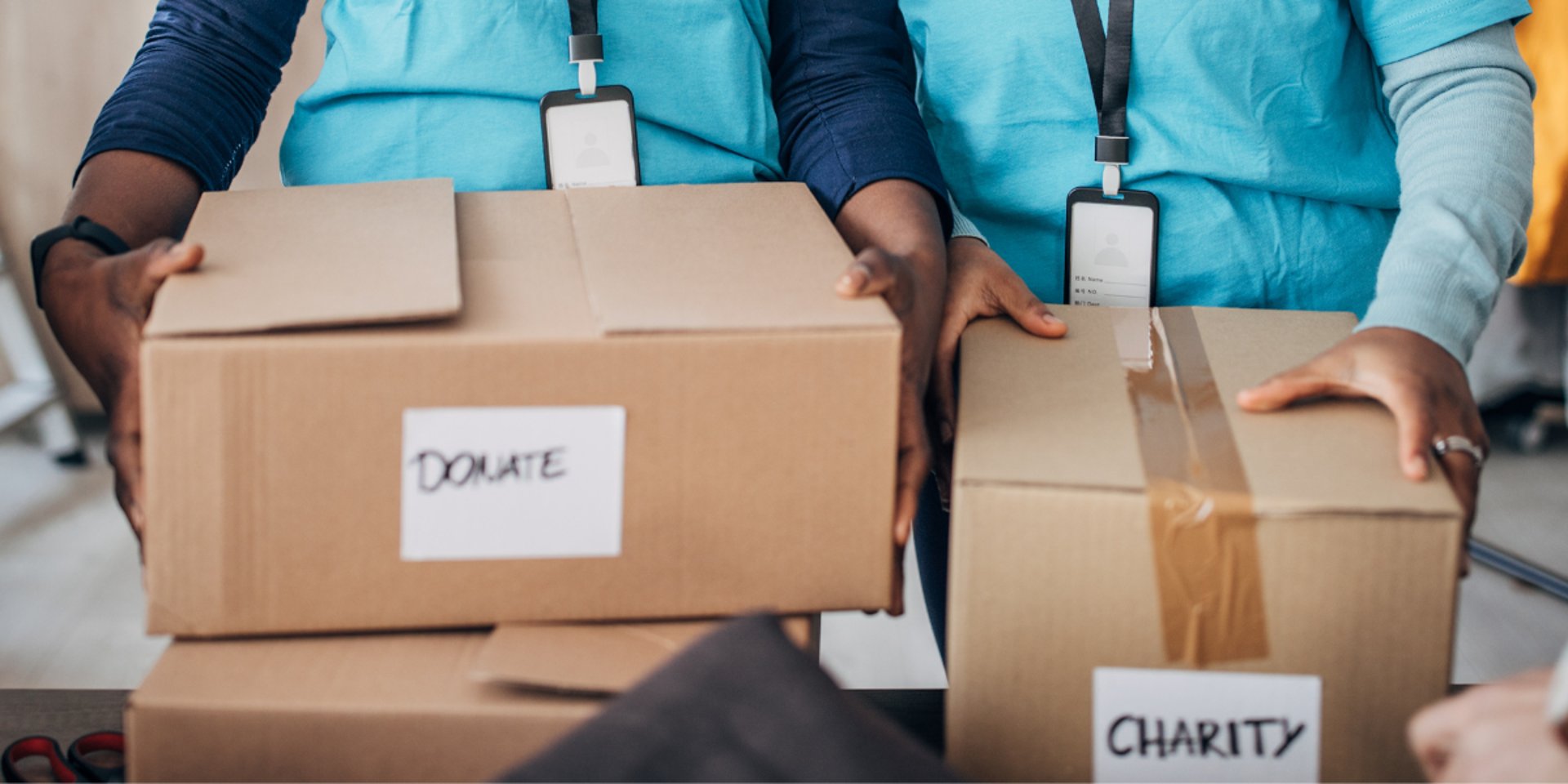 person in red sweater holding babys hand
