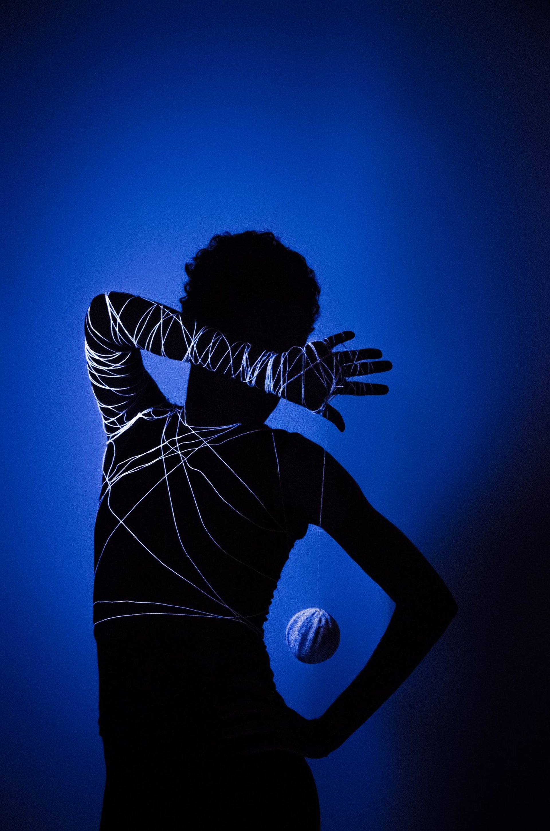 an abstract photo of a curved building with a blue sky in the background
