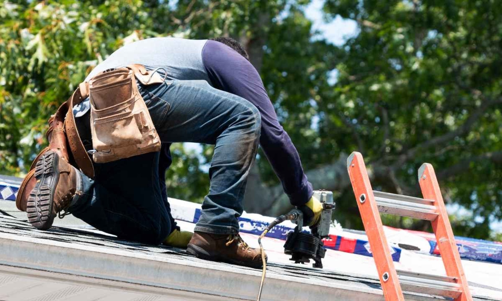 Roofer working on a roof, trying to avoid a Roof Exclusion.