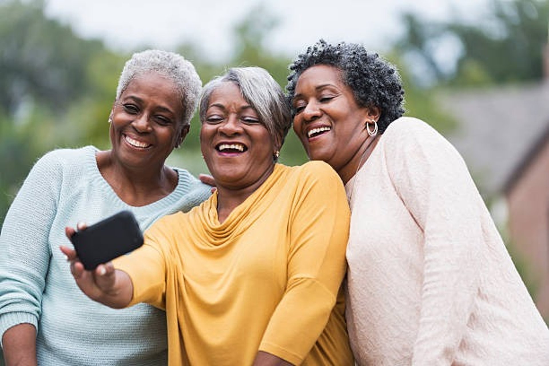 a group of three women standing next to each other