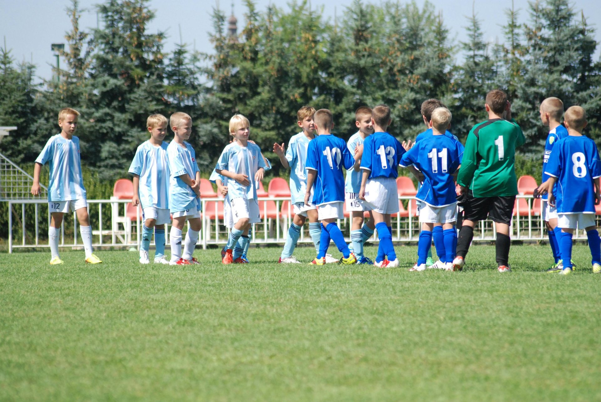 Soccer team huddled together on the field.
