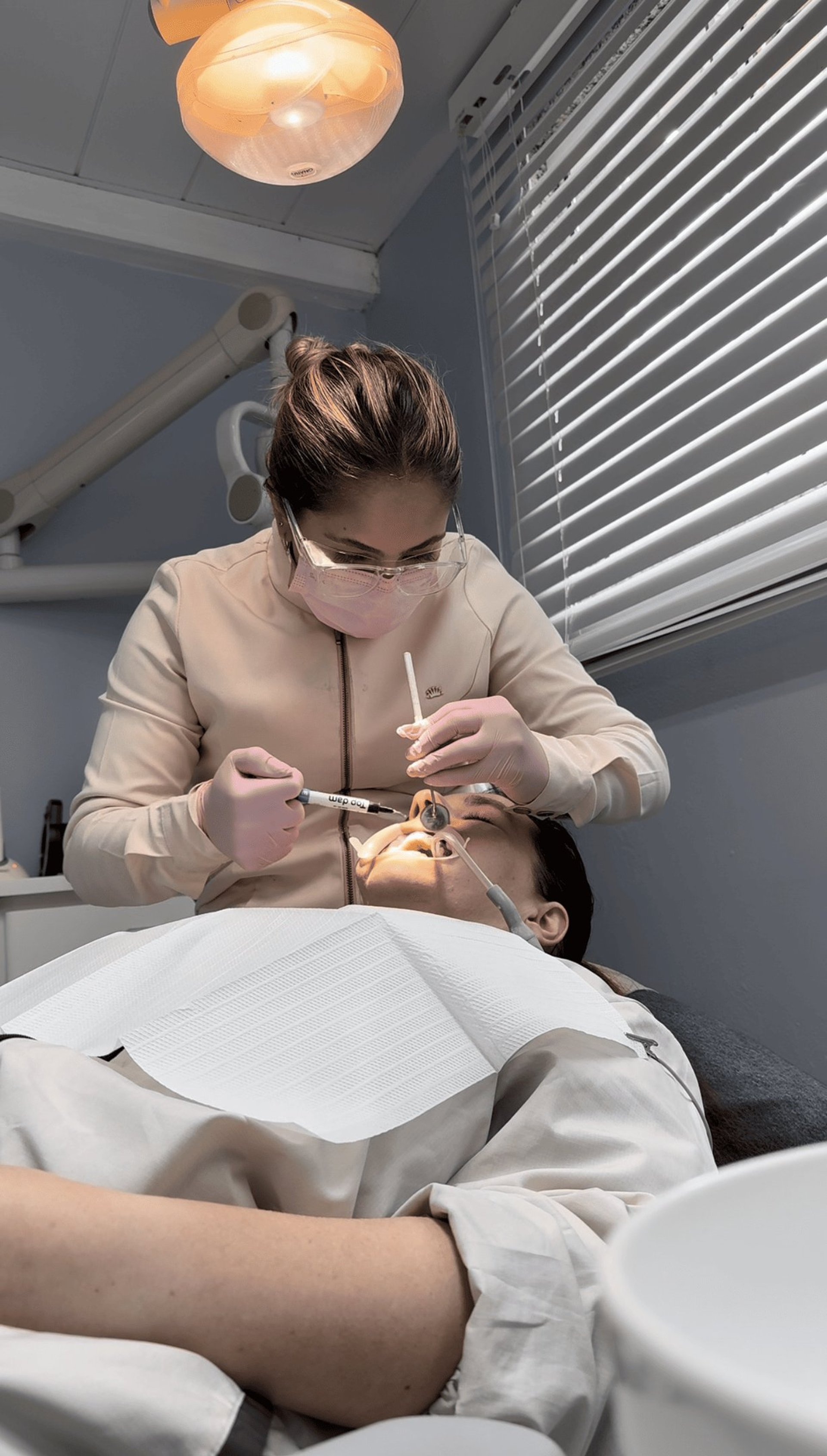 a woman is smiling while holding a toothbrush
