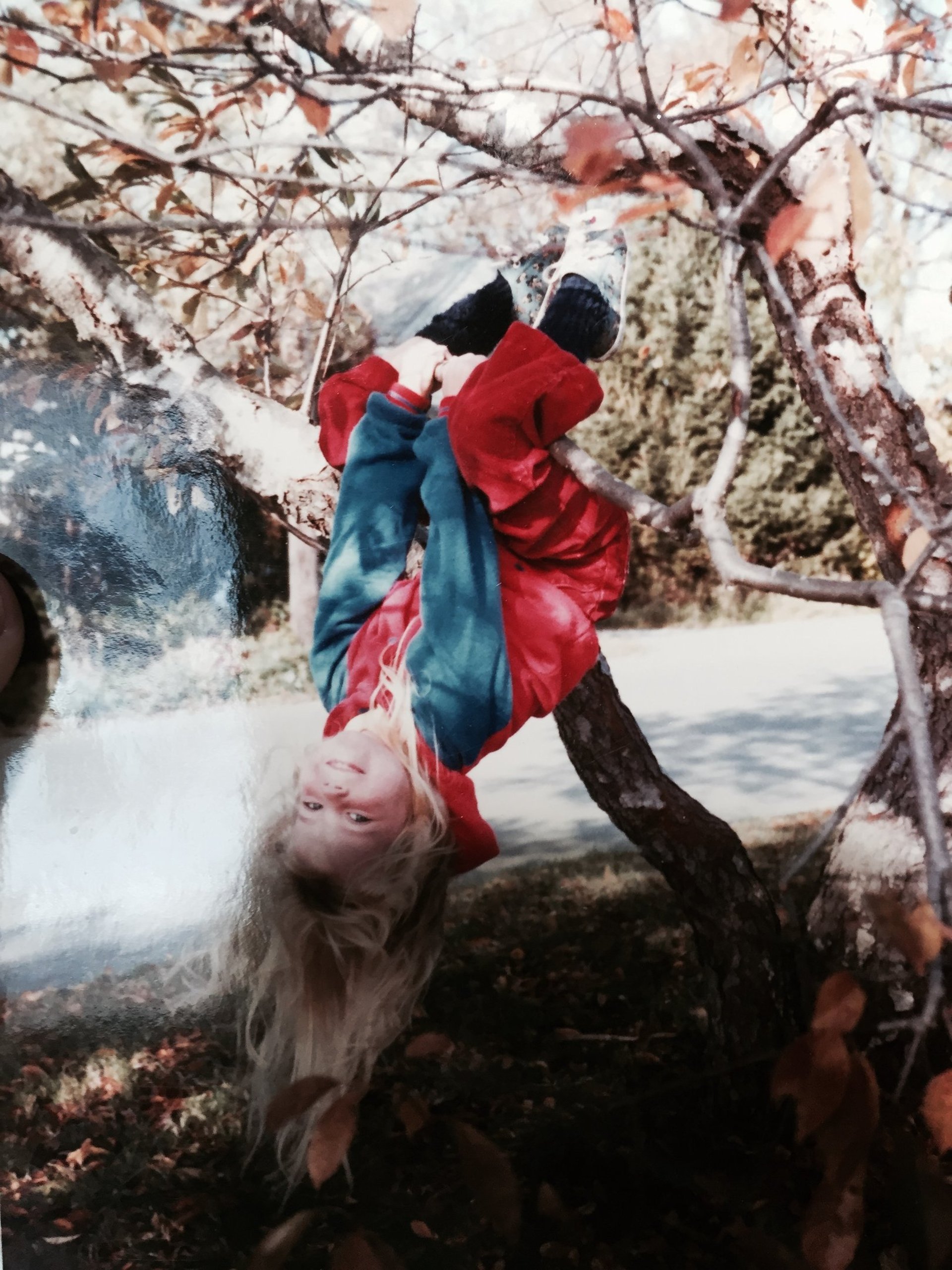 a little girl that is standing in the grass