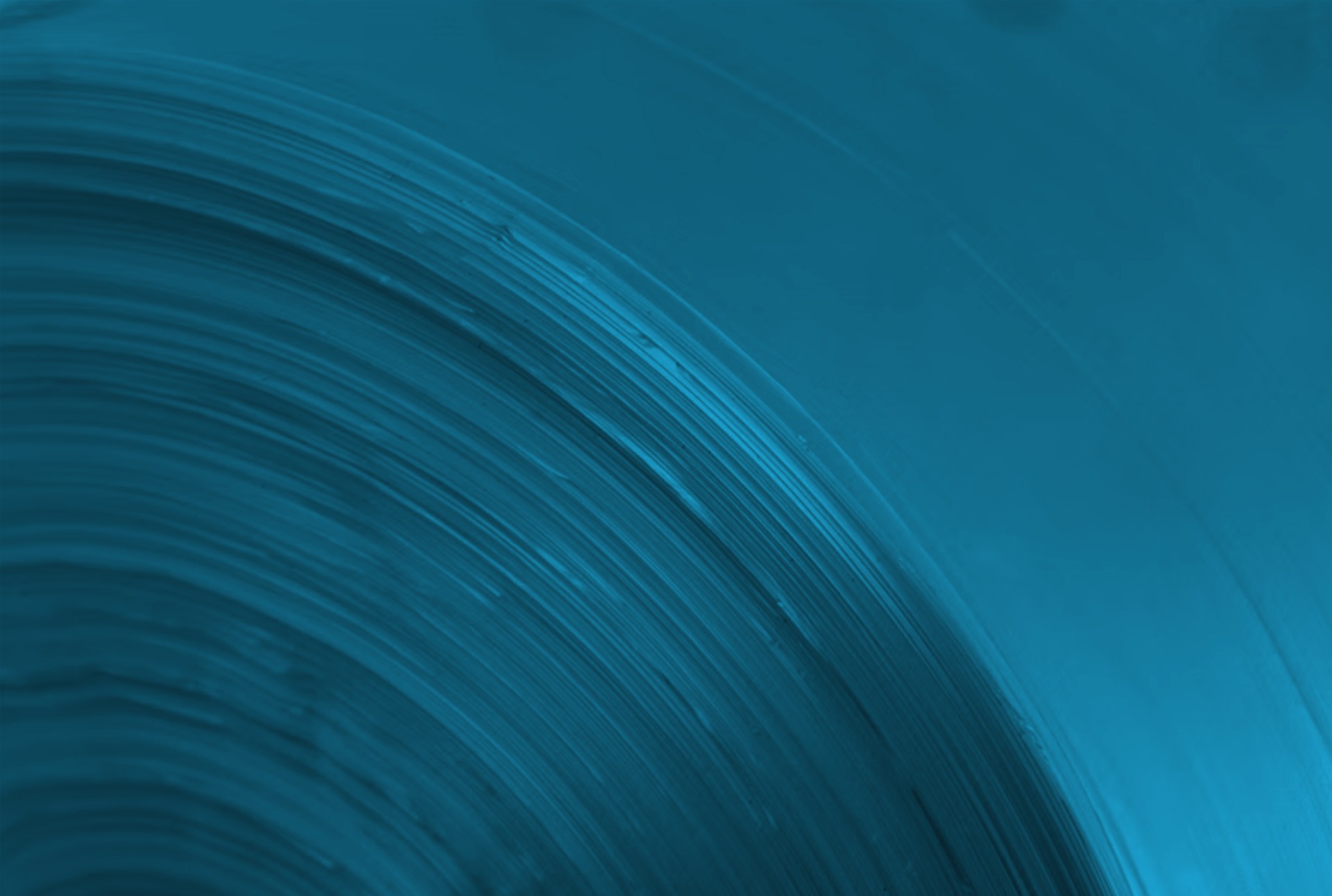 an abstract photo of a curved building with a blue sky in the background